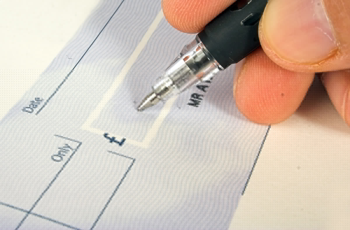 Full image of Signing a cheque.