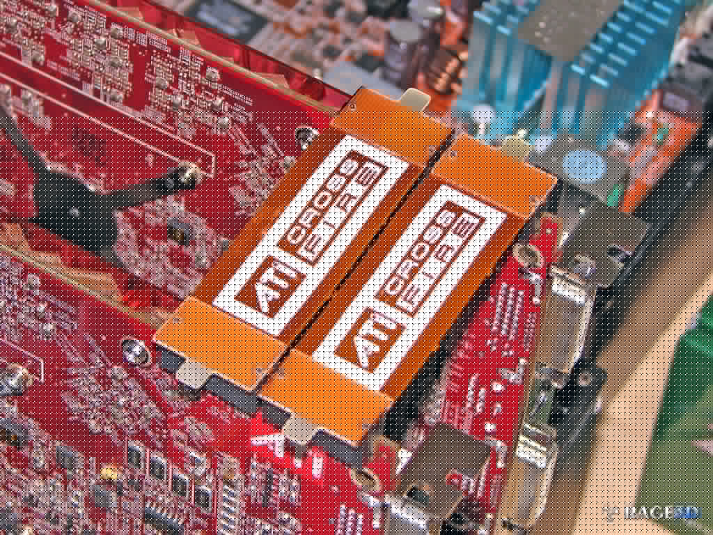 Full image of Two ATI graphics cards linked in "Crossfire" mode using a link cable.