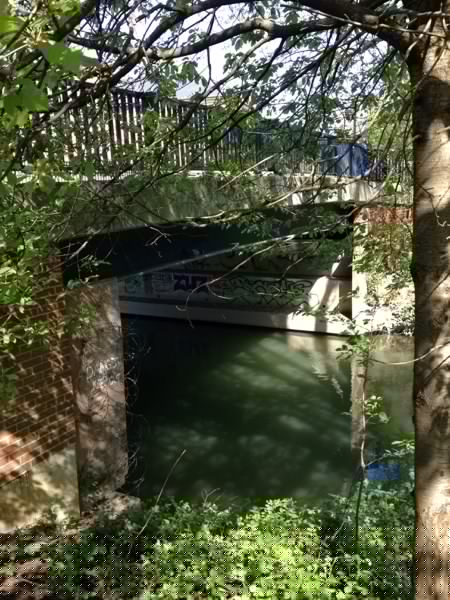 The sides of the bridge, boarded up and with barbed wire. Photo by OxfordLad on Geocaching.com.