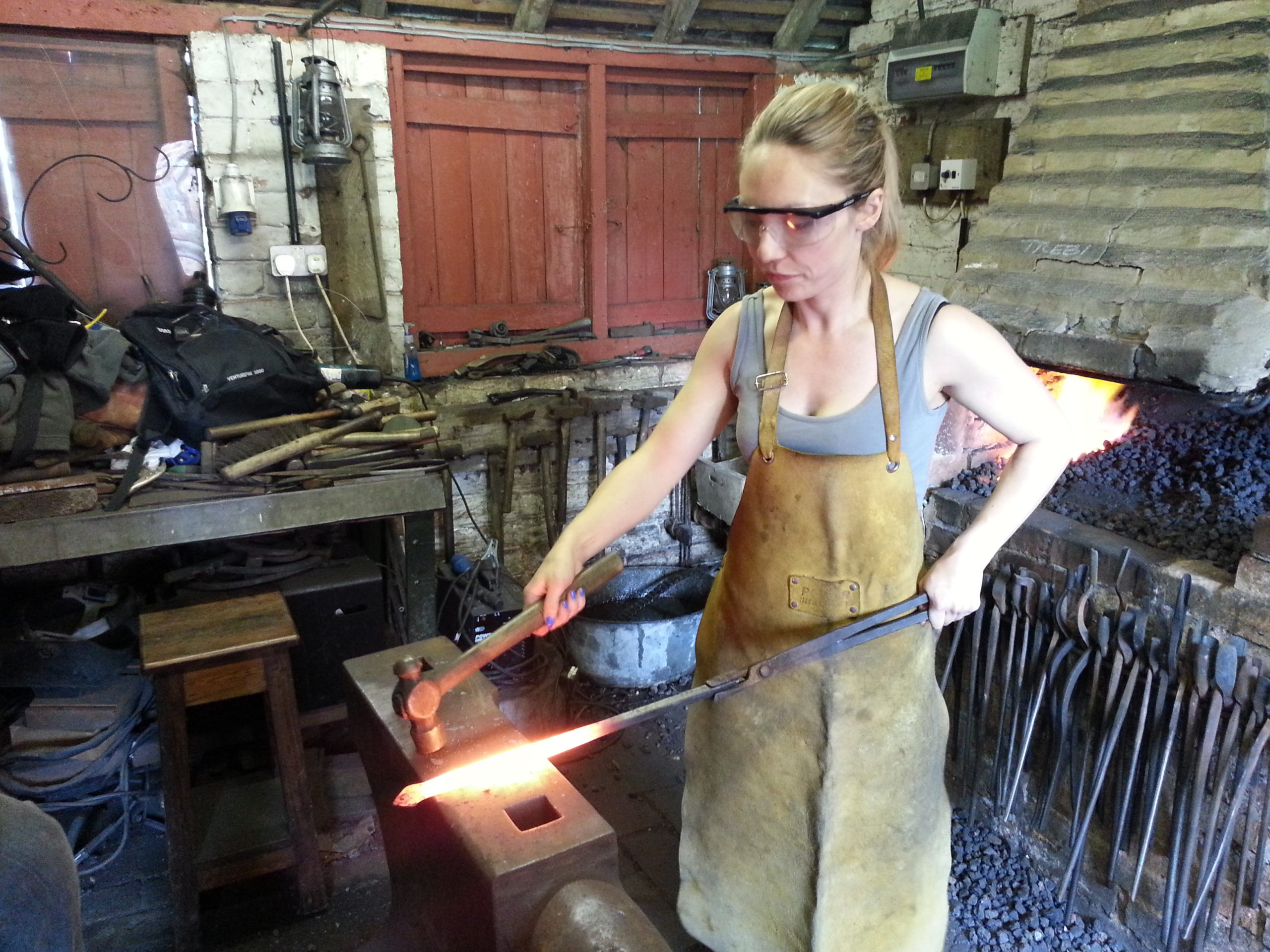 Full image of Liz tapering the stem of her poker. Like a pro.