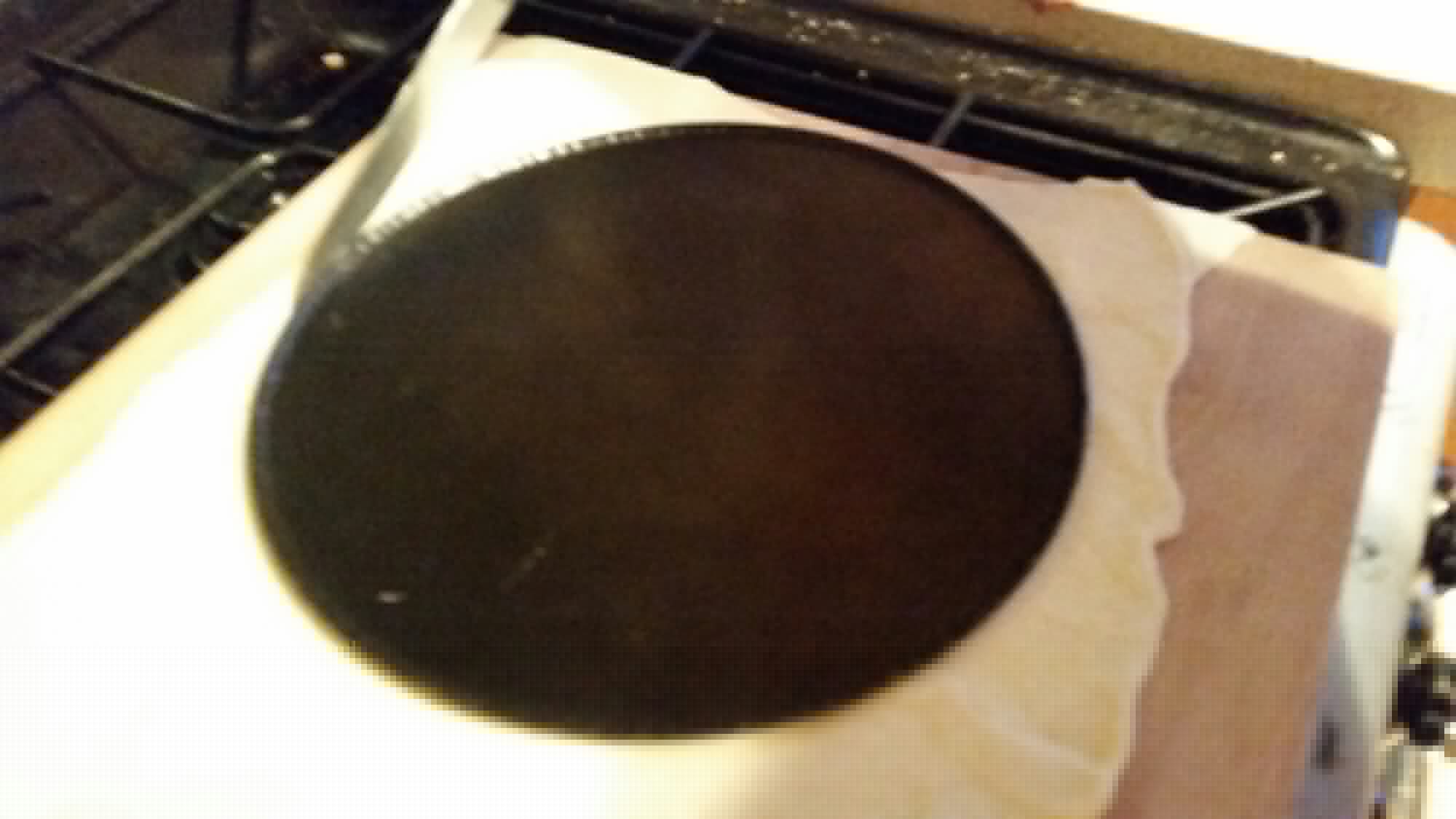 Full image of Rolled dough being cut into a circle.