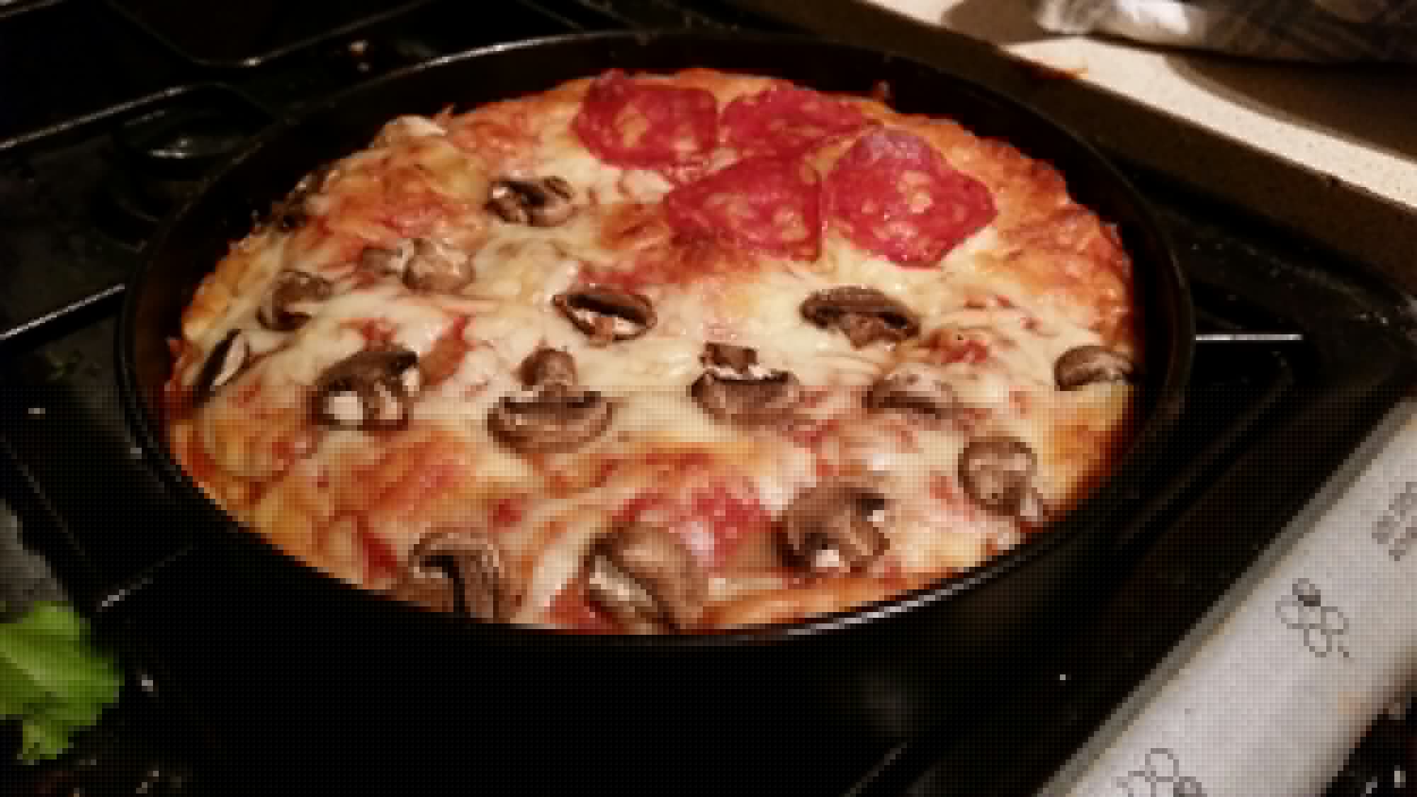 Full image of Pizza cake freshly removed from the oven.