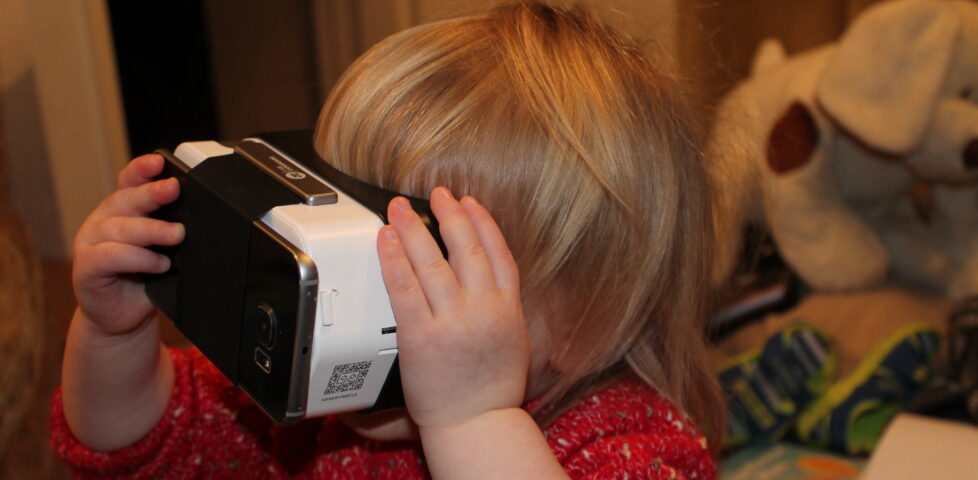 Annabel plays with a Google Cardboard with a Samsung Galaxy S6 Edge attached.