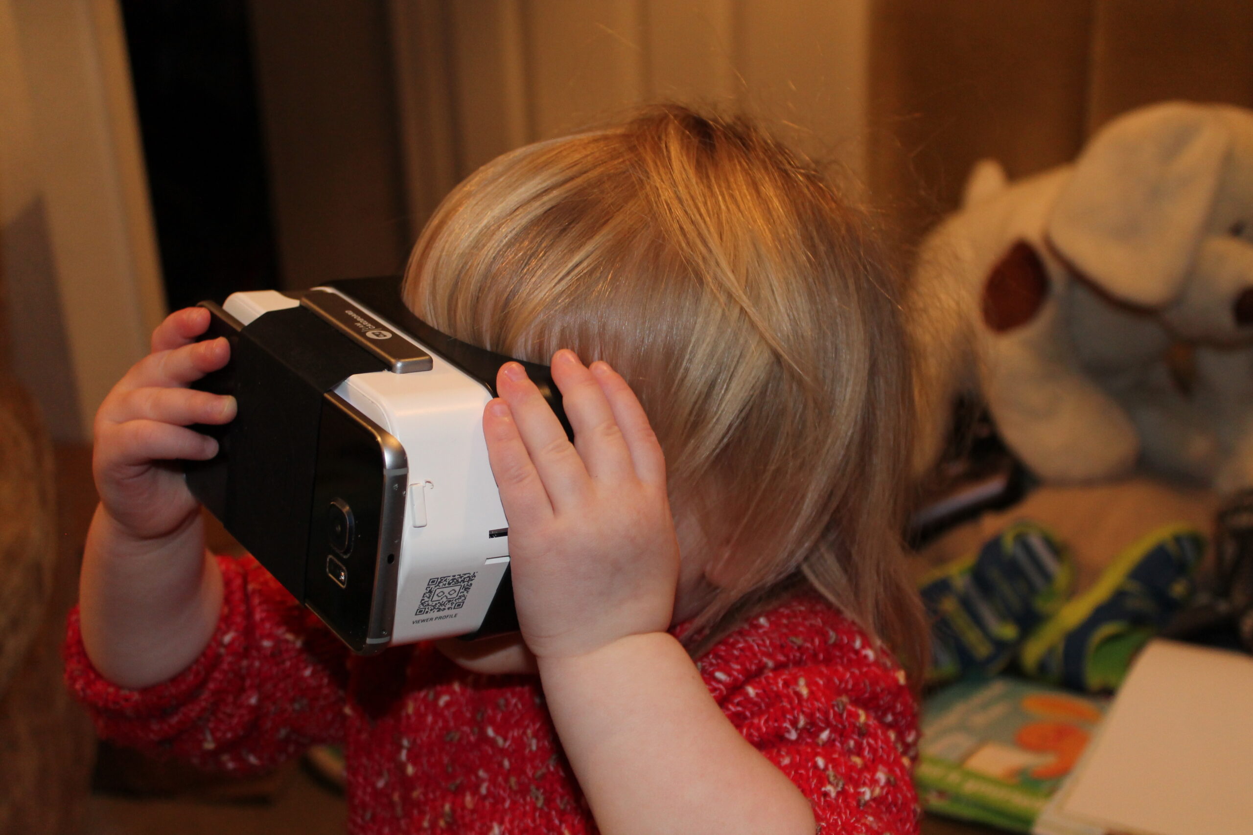 Full image of Annabel plays with a Google Cardboard with a Samsung Galaxy S6 Edge attached.