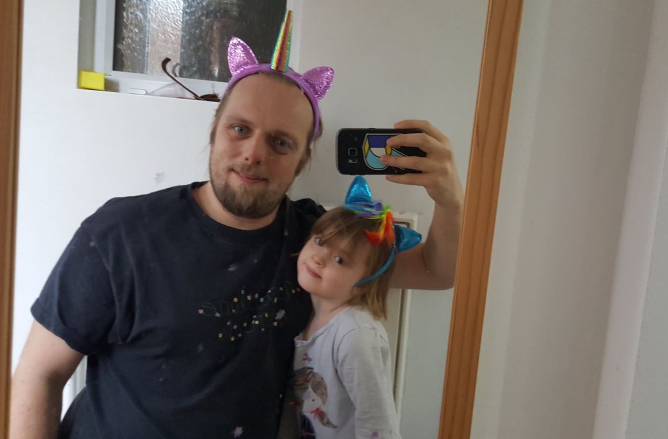 Full image of Dan and Annabel wearing My Little Pony headbands. Dan is also wearing a T-shirt that reads "Masculine as fuck", written in flowers, although he hadn't thought about that at the time.