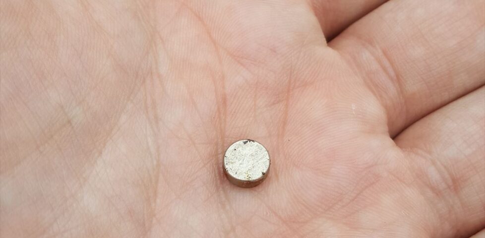 Nano cache magnet, detached, in Dan's hand.