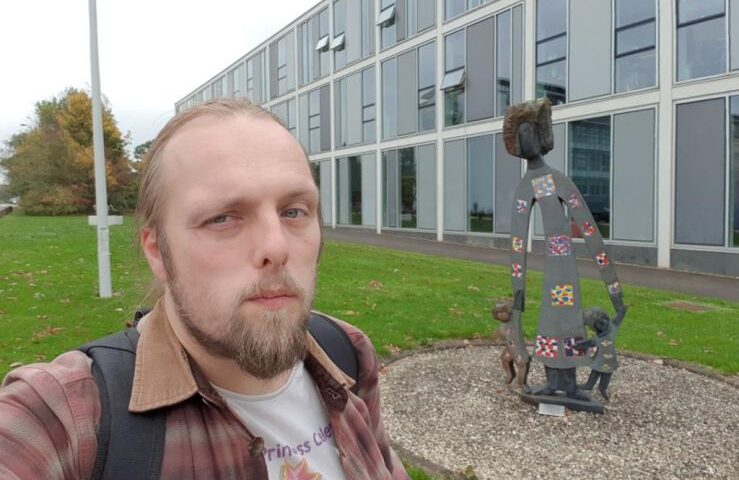 Dan at a statue of a woman with children