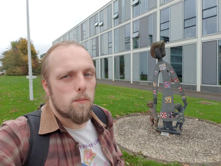 Dan at a statue of a woman with children