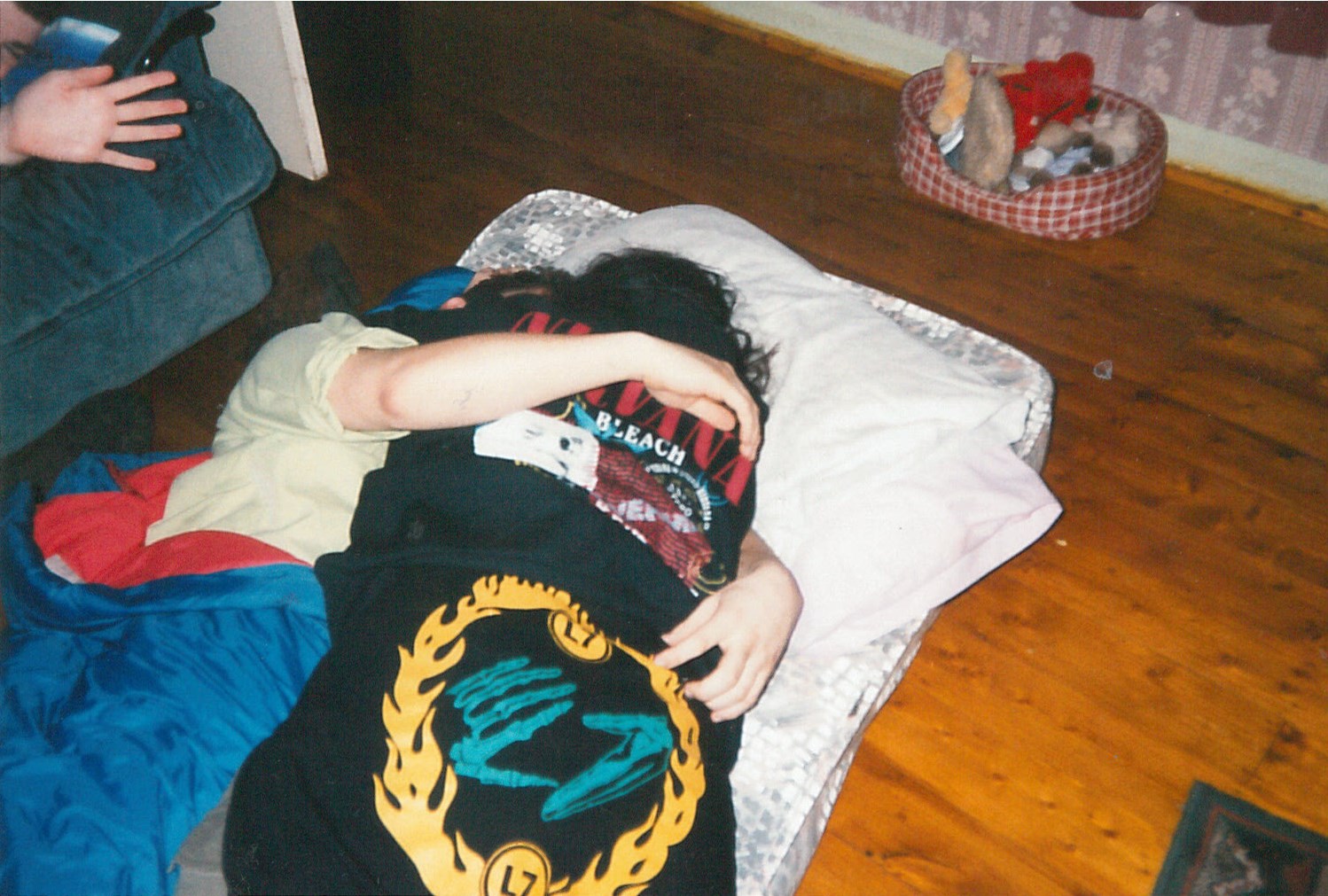 Full image of Gary and Faye embracing on a sleeping bag