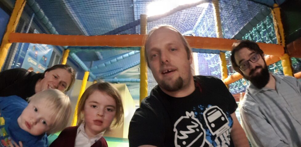 Ruth, Dan, JTA and the kids at the top of the slides at a soft play area.