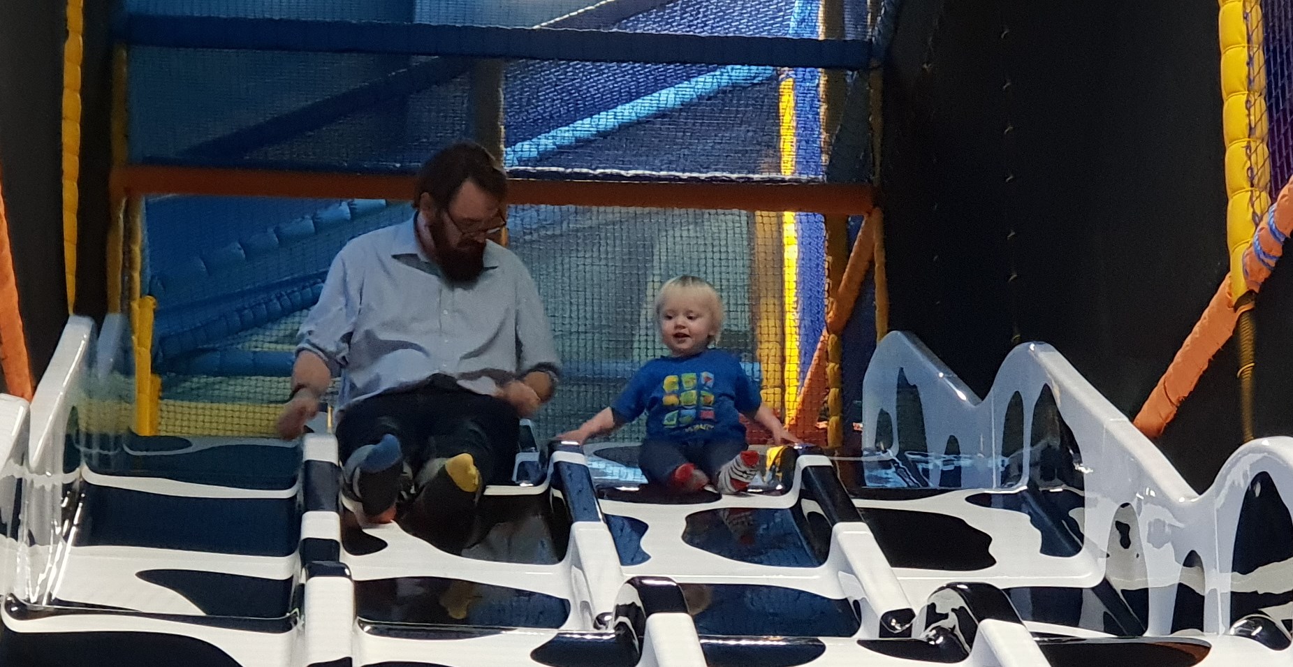 Full image of JTA with his youngest, on a slide.