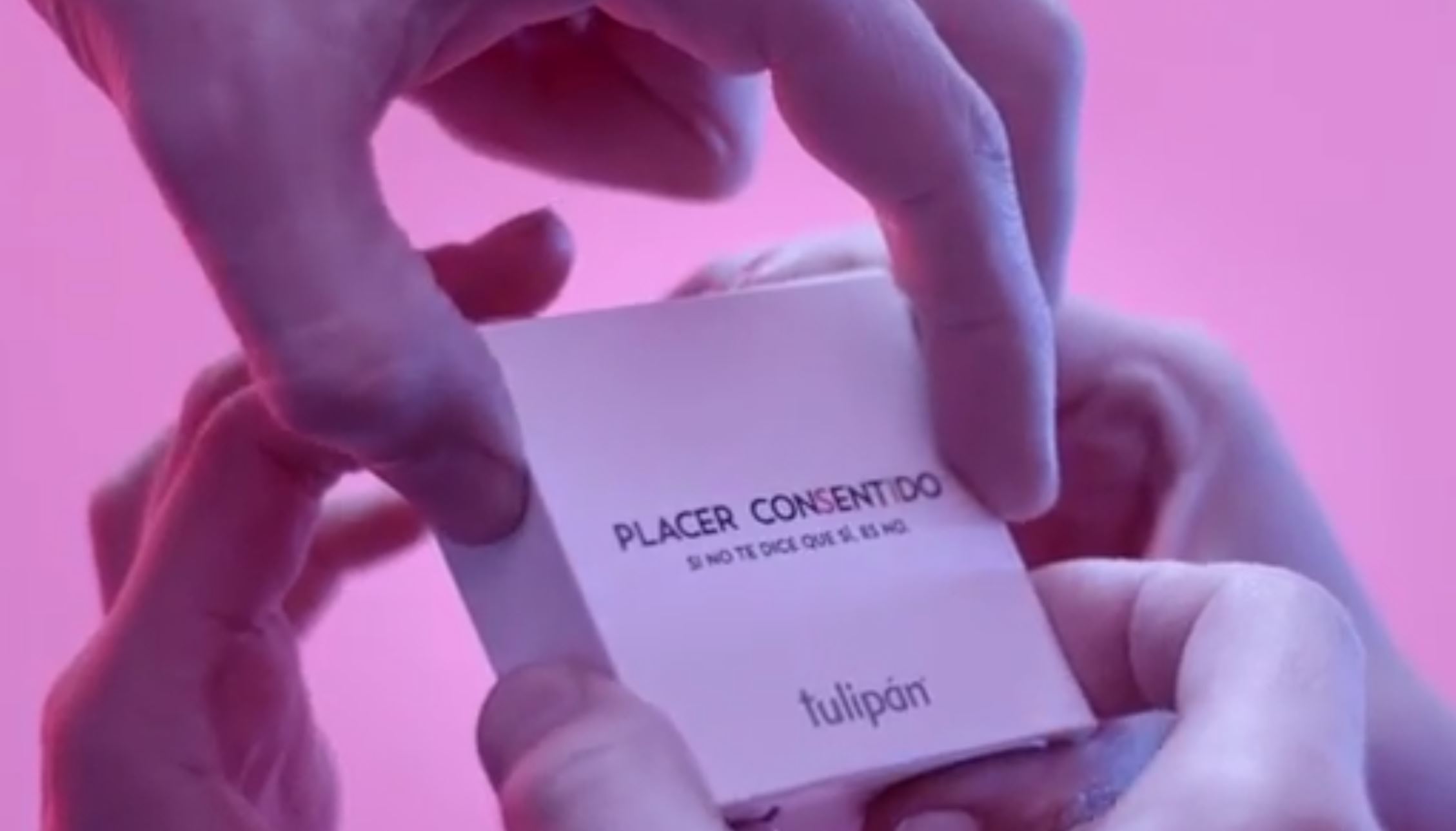 Full image of Hands moving to the magic pressure points on a condom packet.