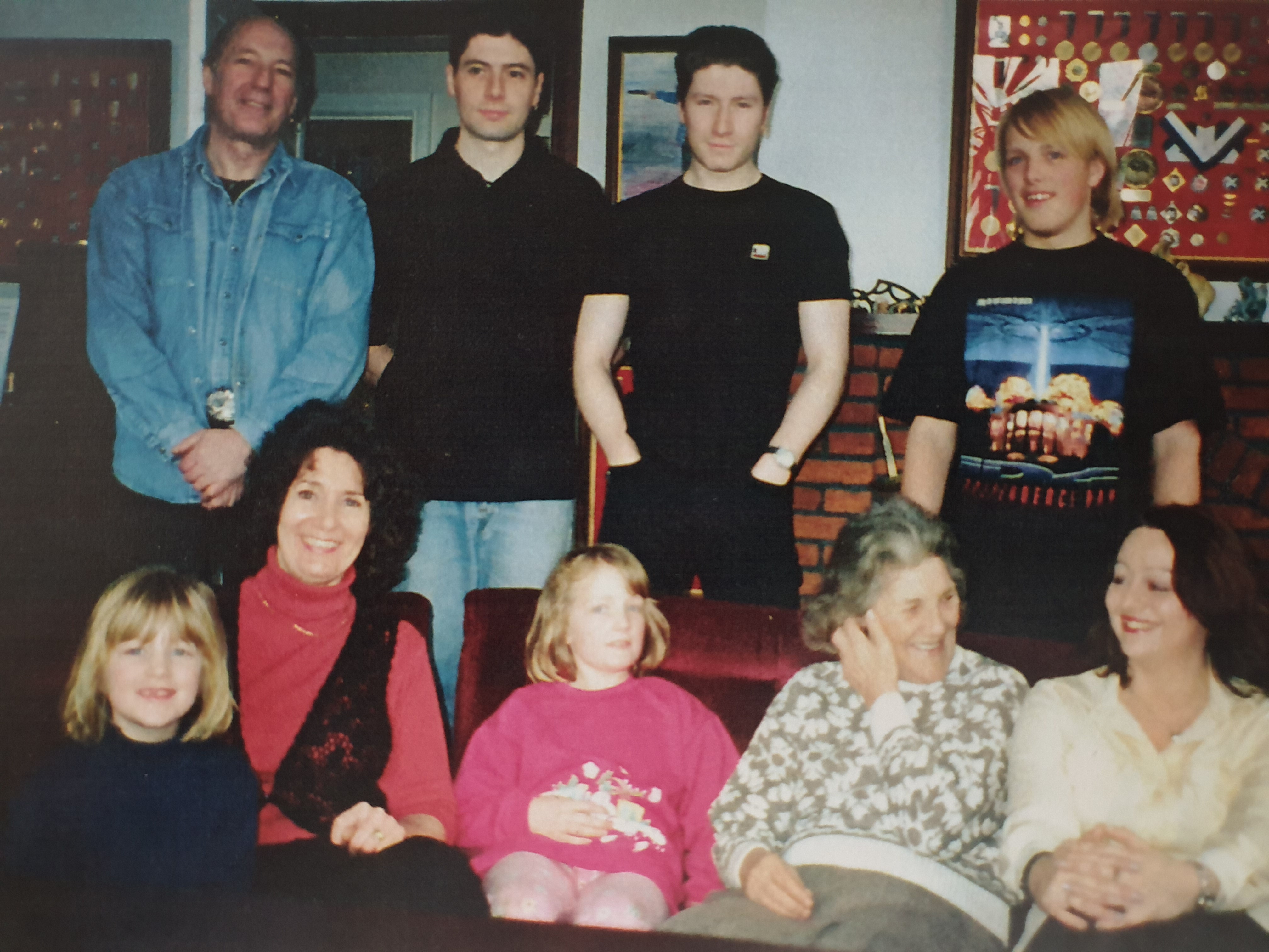 Full image of Dan with his Uncle Tom, Aunt Anne, cousins Thomas and Stephen, sisters, grandmother, and a woman who's probably the girlfriend of one of his cousins