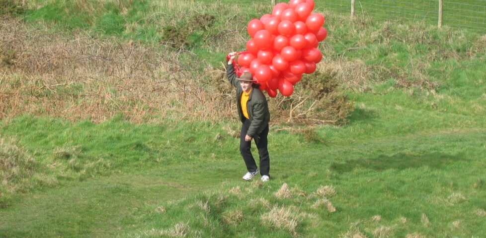 Paul approaches carrying the balloons