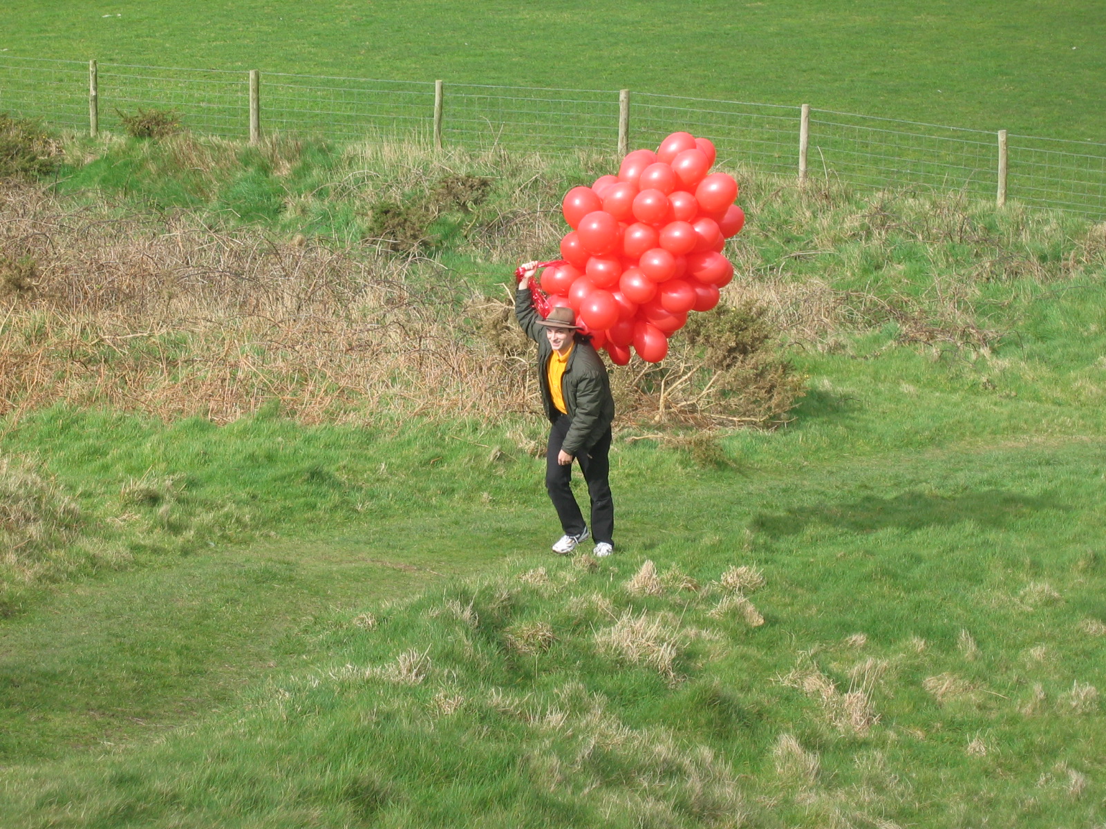Full image of Paul approaches carrying the balloons