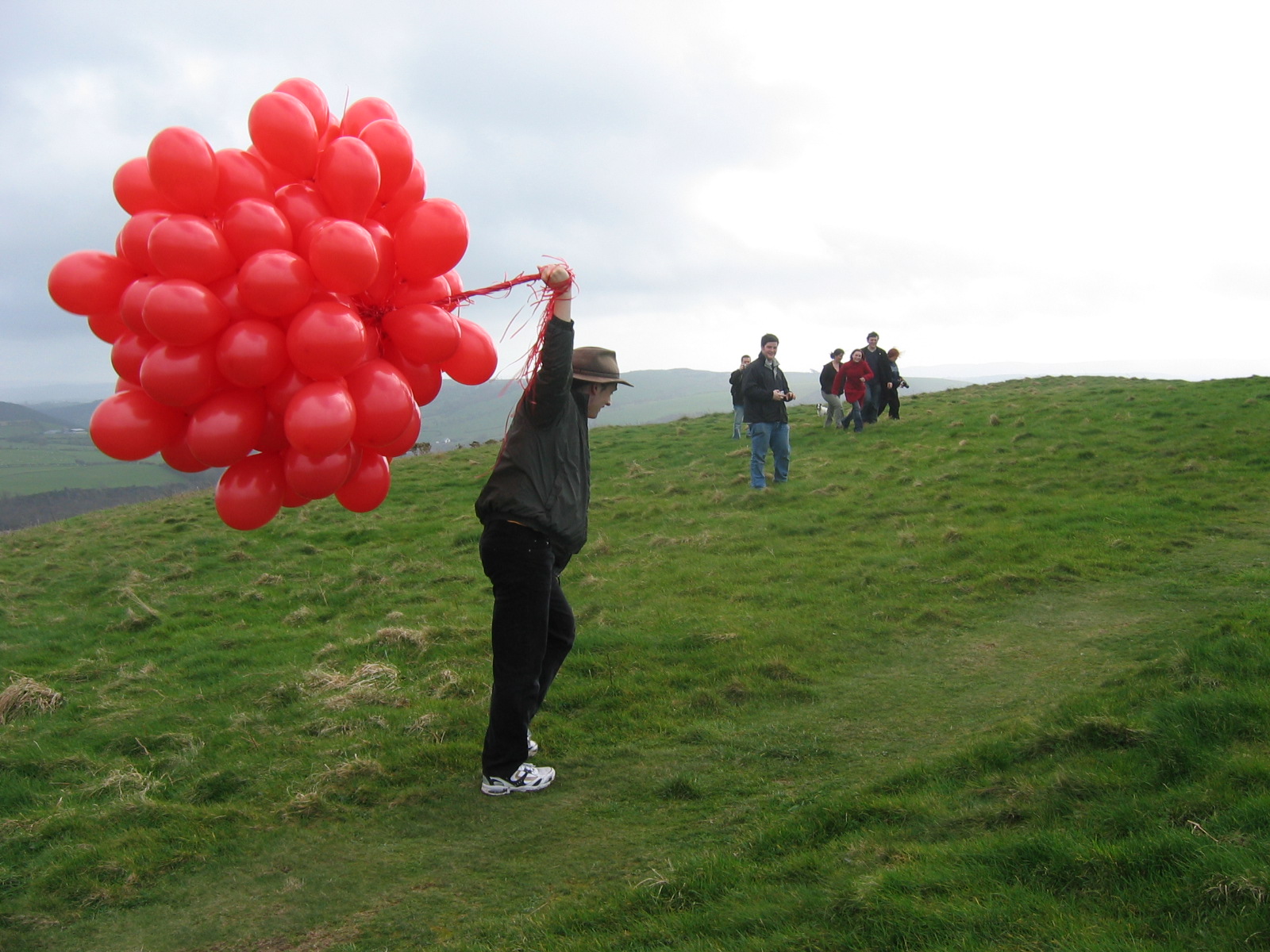 Full image of Paul struggles to bring the balloons to the very top