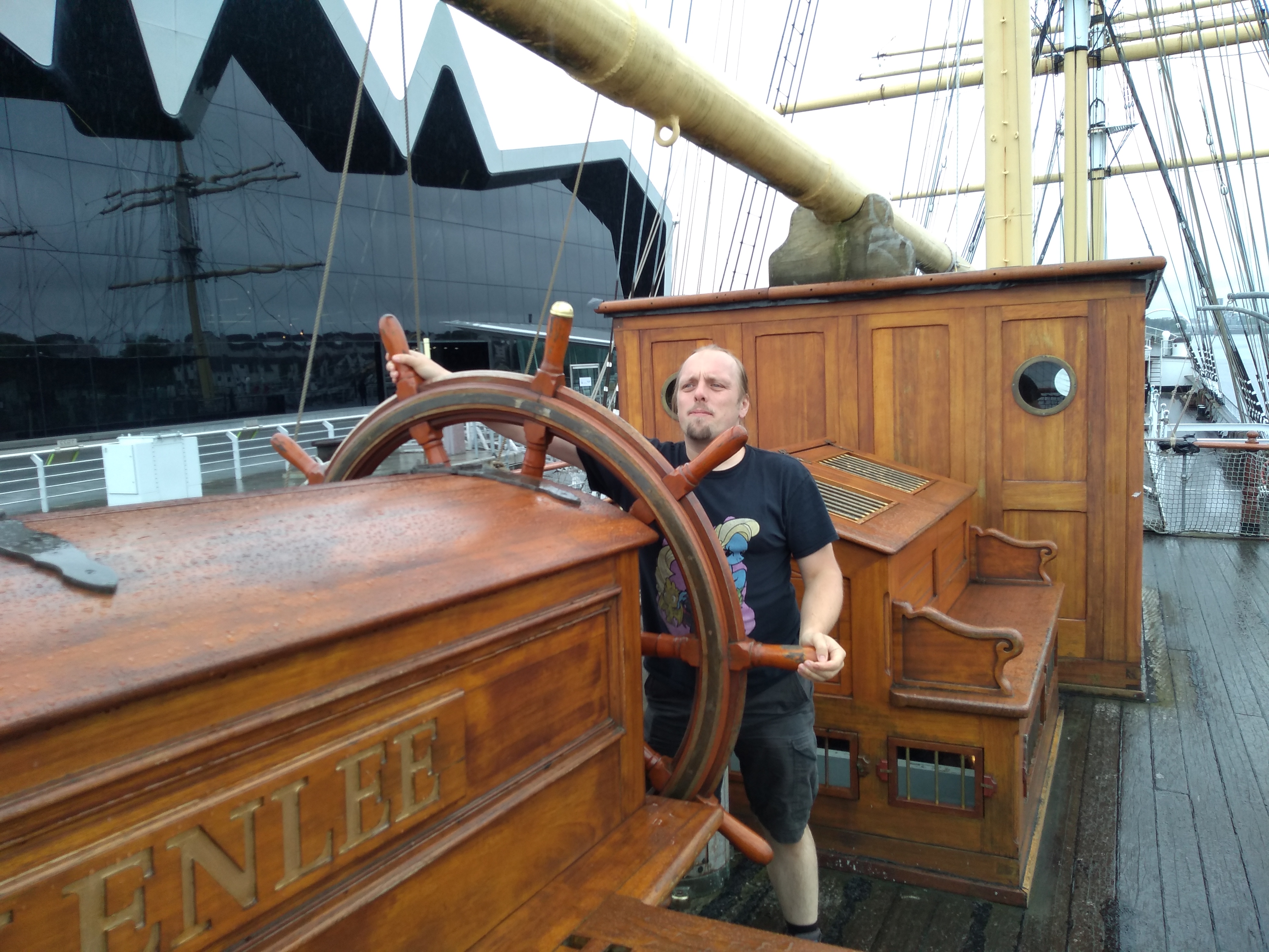 Full image of Dan at the wheel of the Glenlee