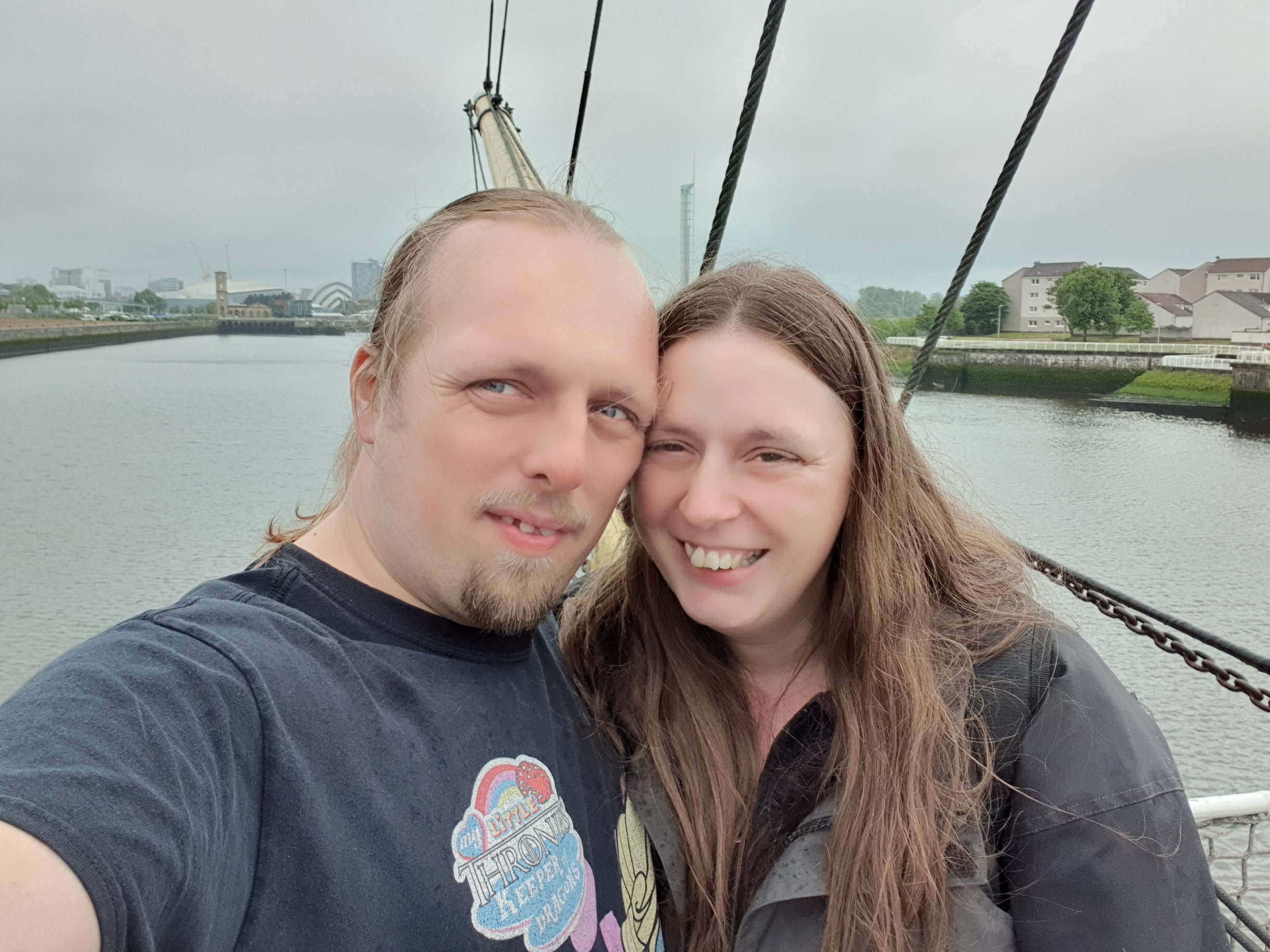 Full image of Dan and Ruth, windswept and wet, aboard the Glenlee in Glasgow.