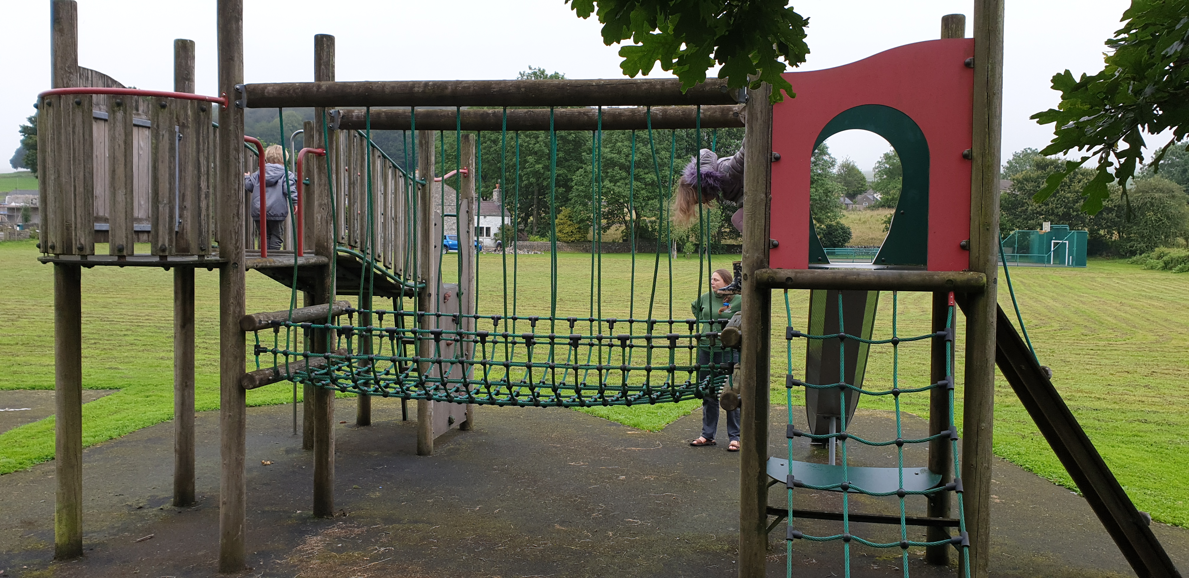 Full image of John and Annabel on the climbing frame.