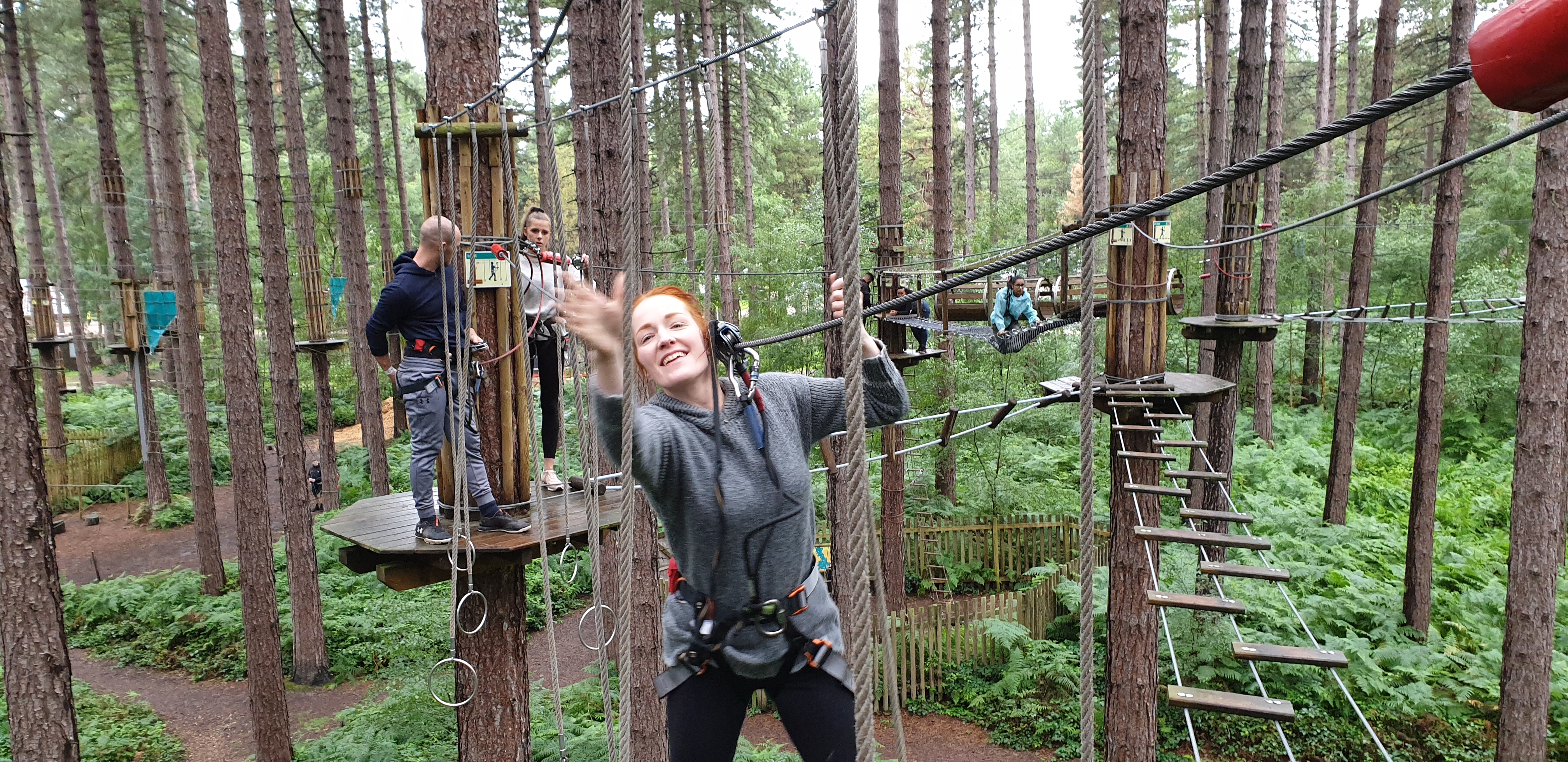 Full image of Sarah swings into the rings crossing.