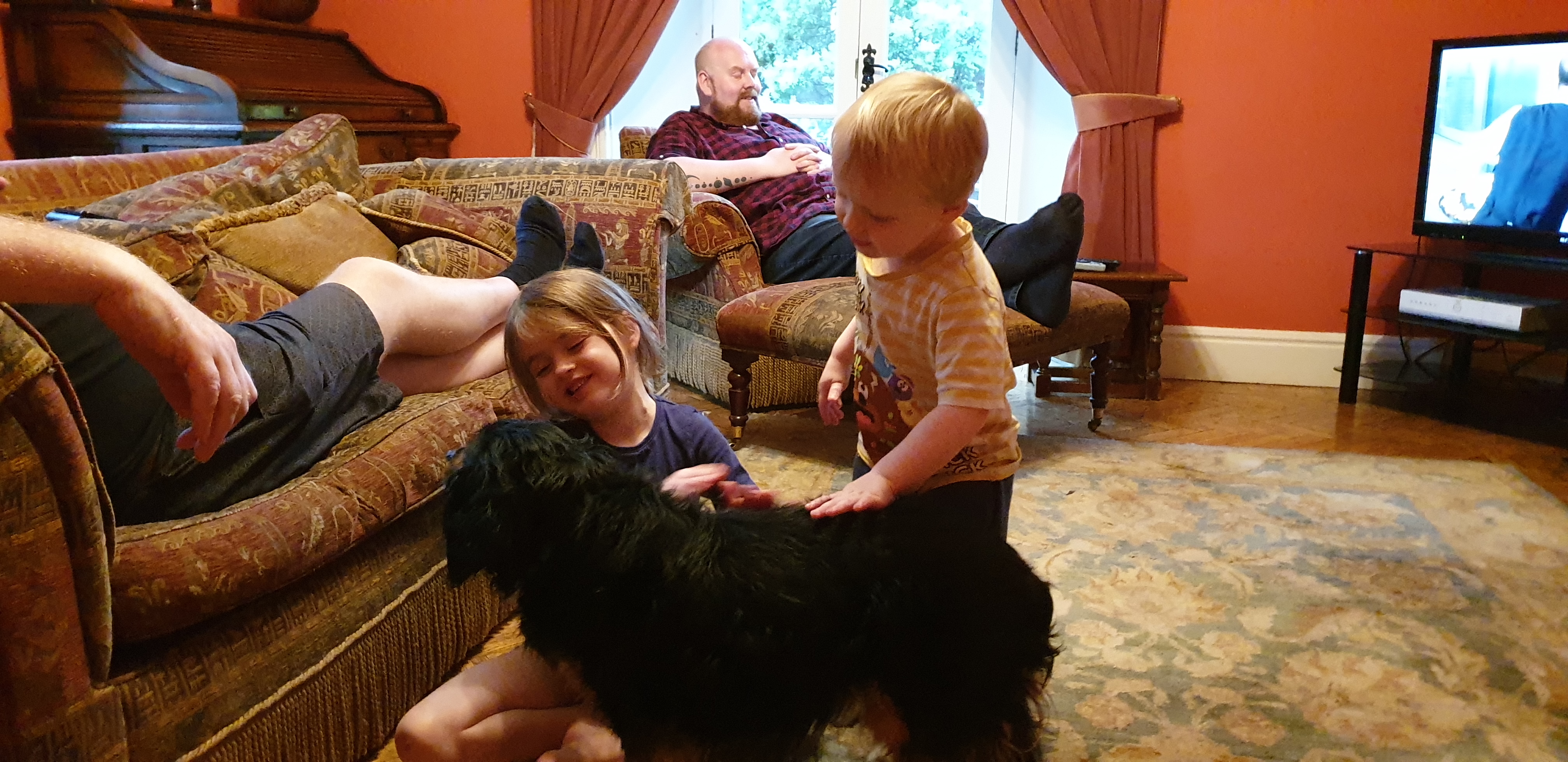 Full image of Annabel and John pet Rufus the dog.