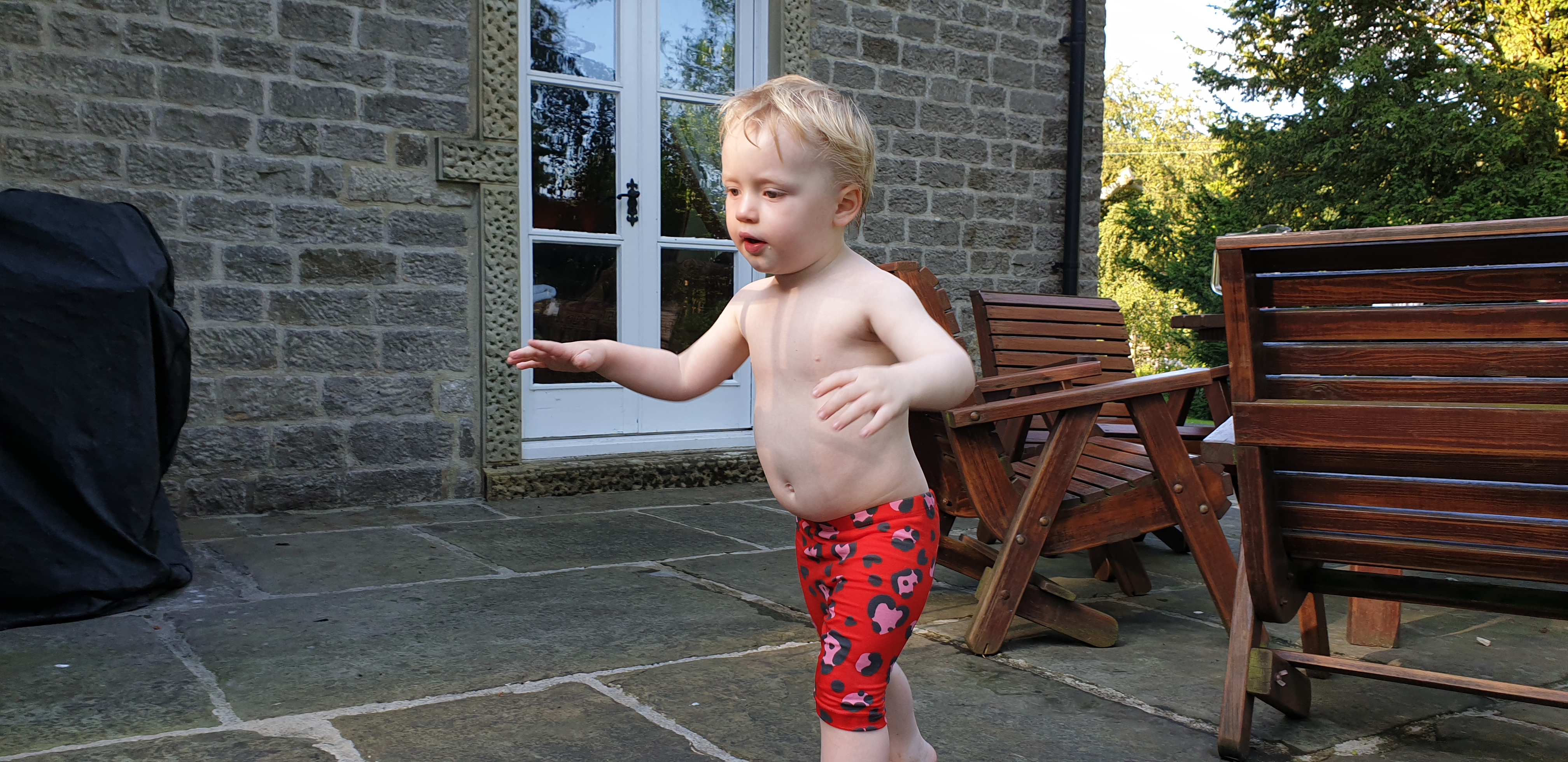 Full image of John runs around in his shorts.