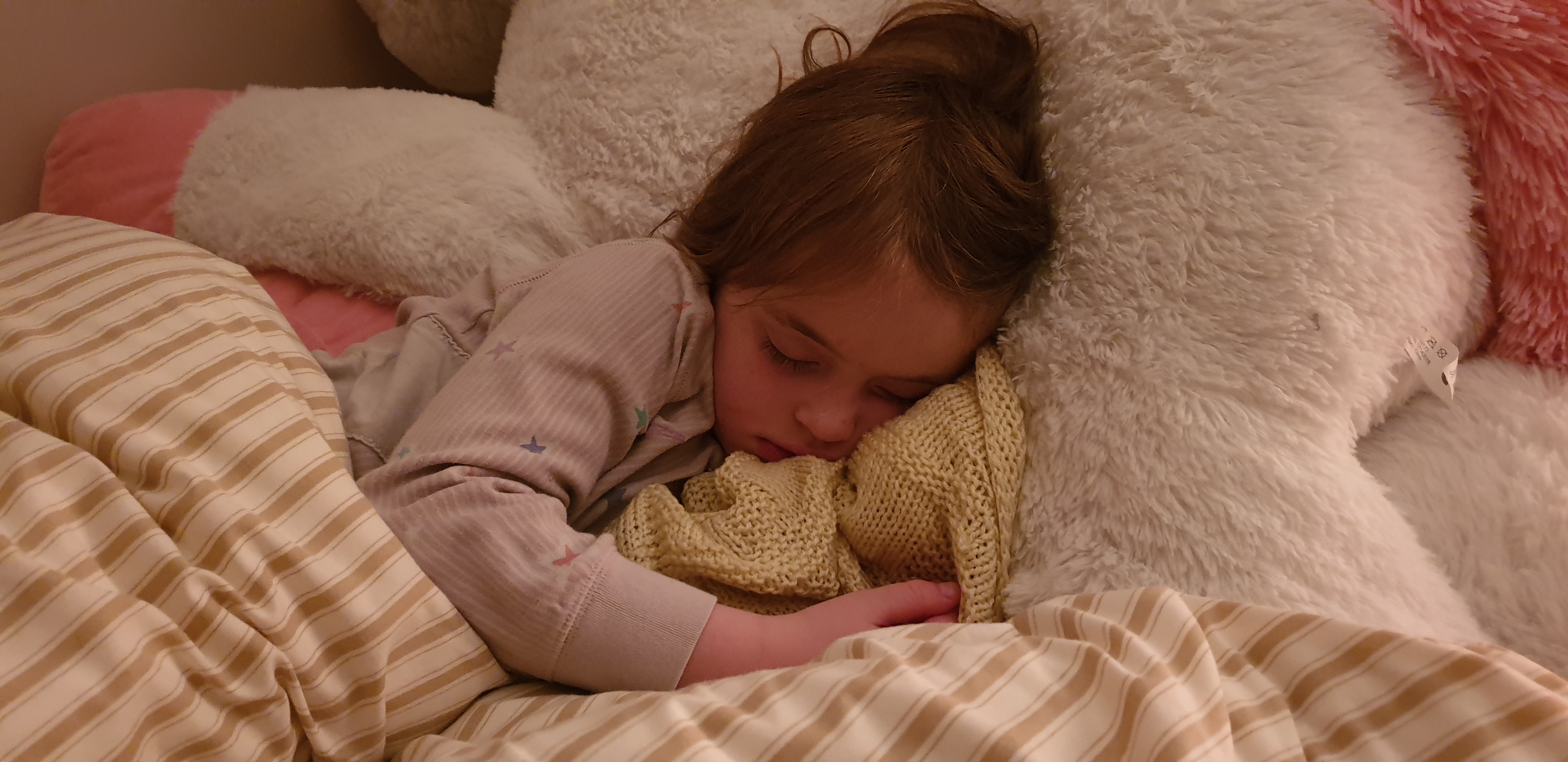 Full image of Annabel asleep with her blanket.