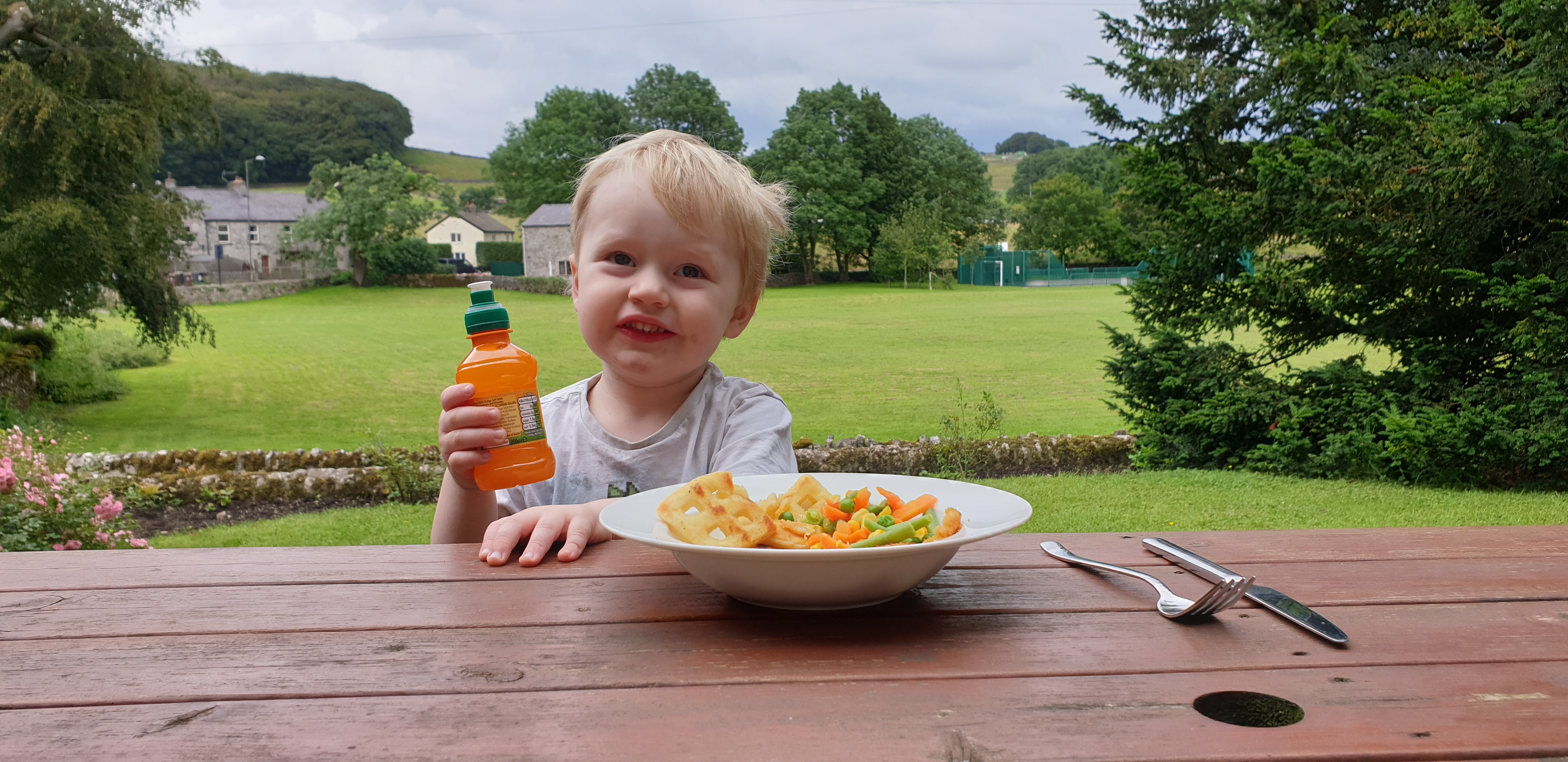 Full image of John eats fish fingers outdoors #1.