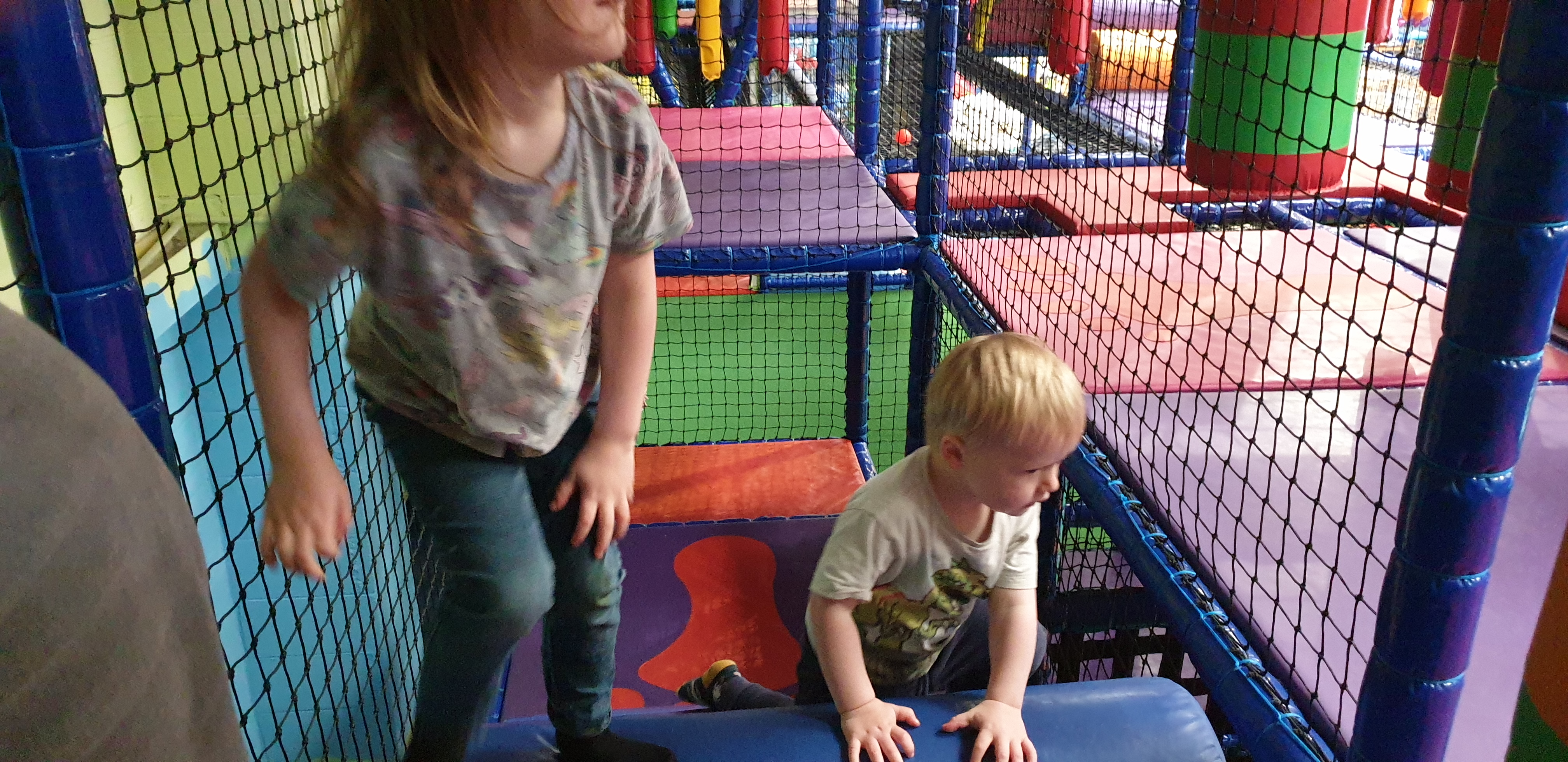 Full image of John and Annabel explore the soft play area.
