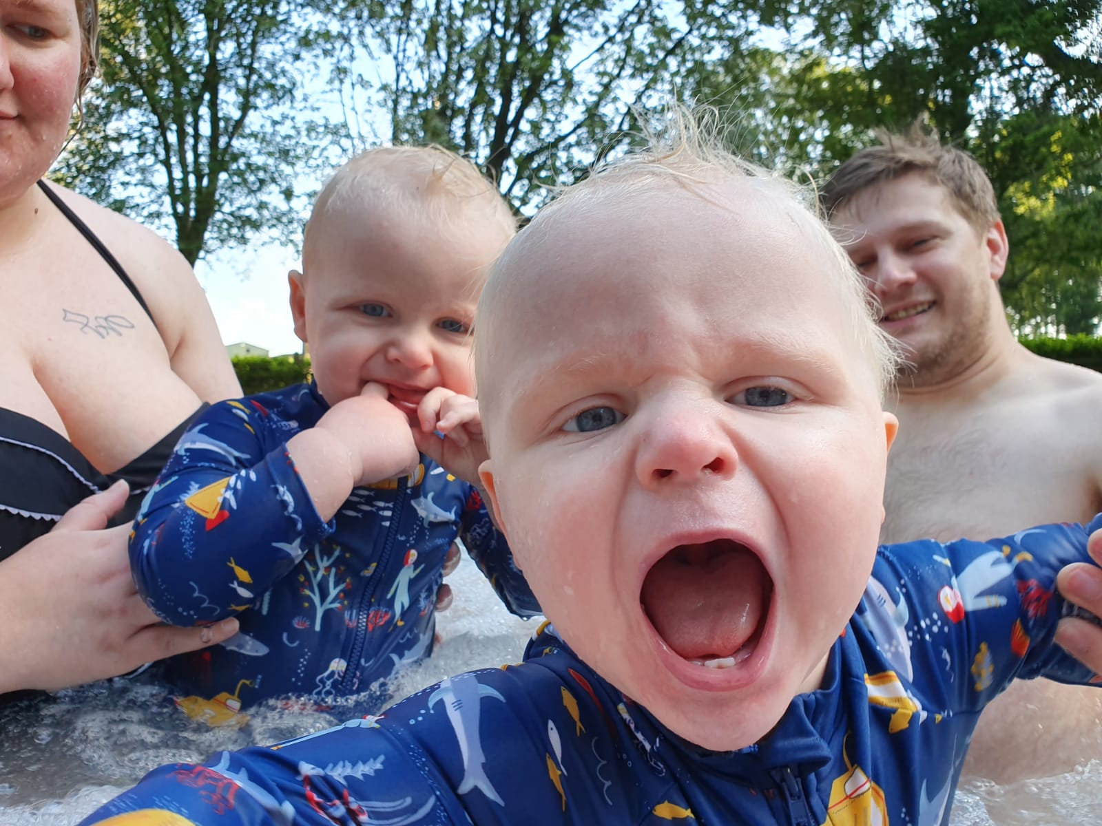 Full image of The twins, excited, in the hot tub.