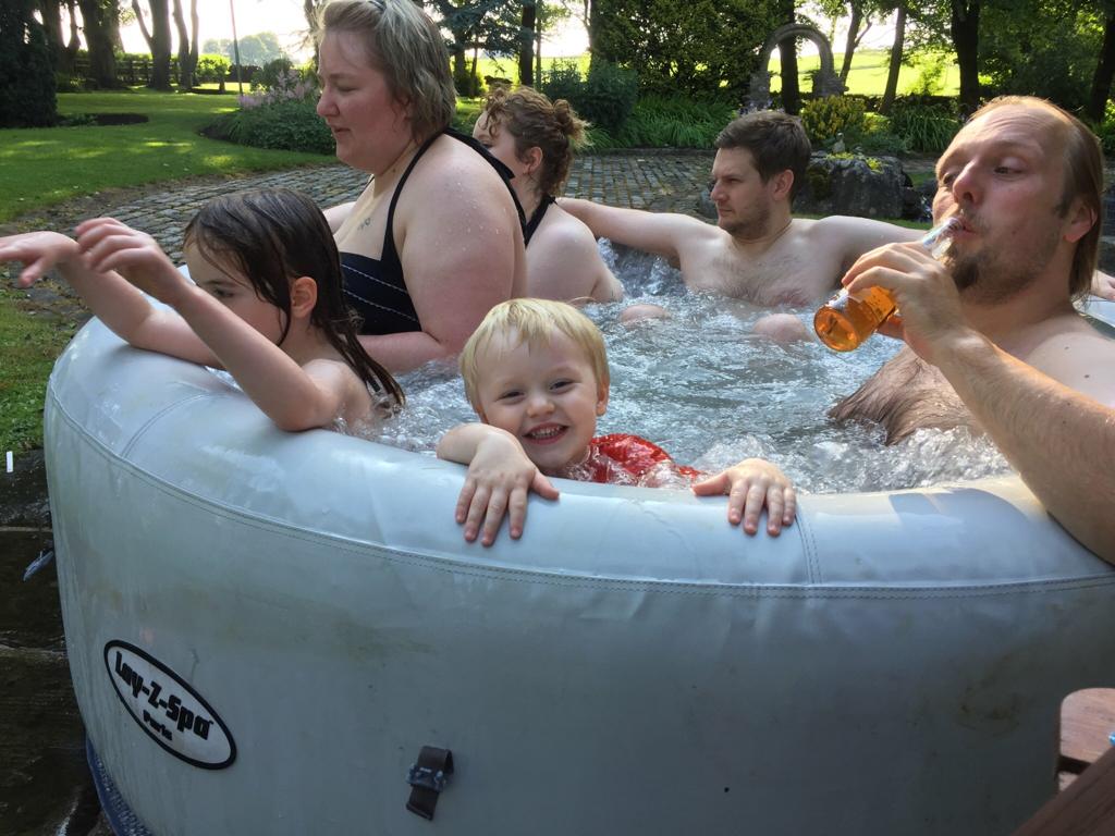 Full image of John in a crowded hot tub.