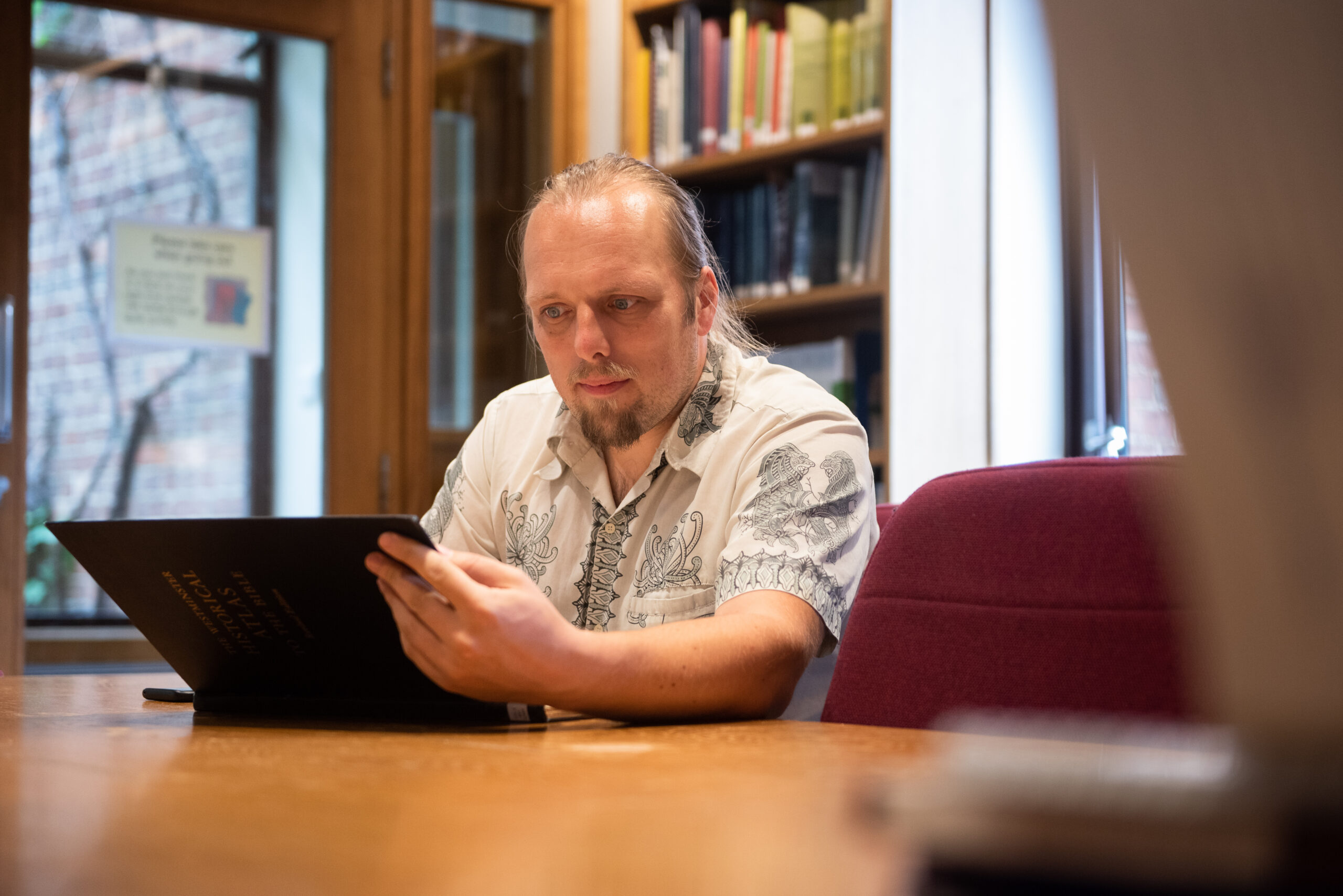 Full image of Dan reads a book.