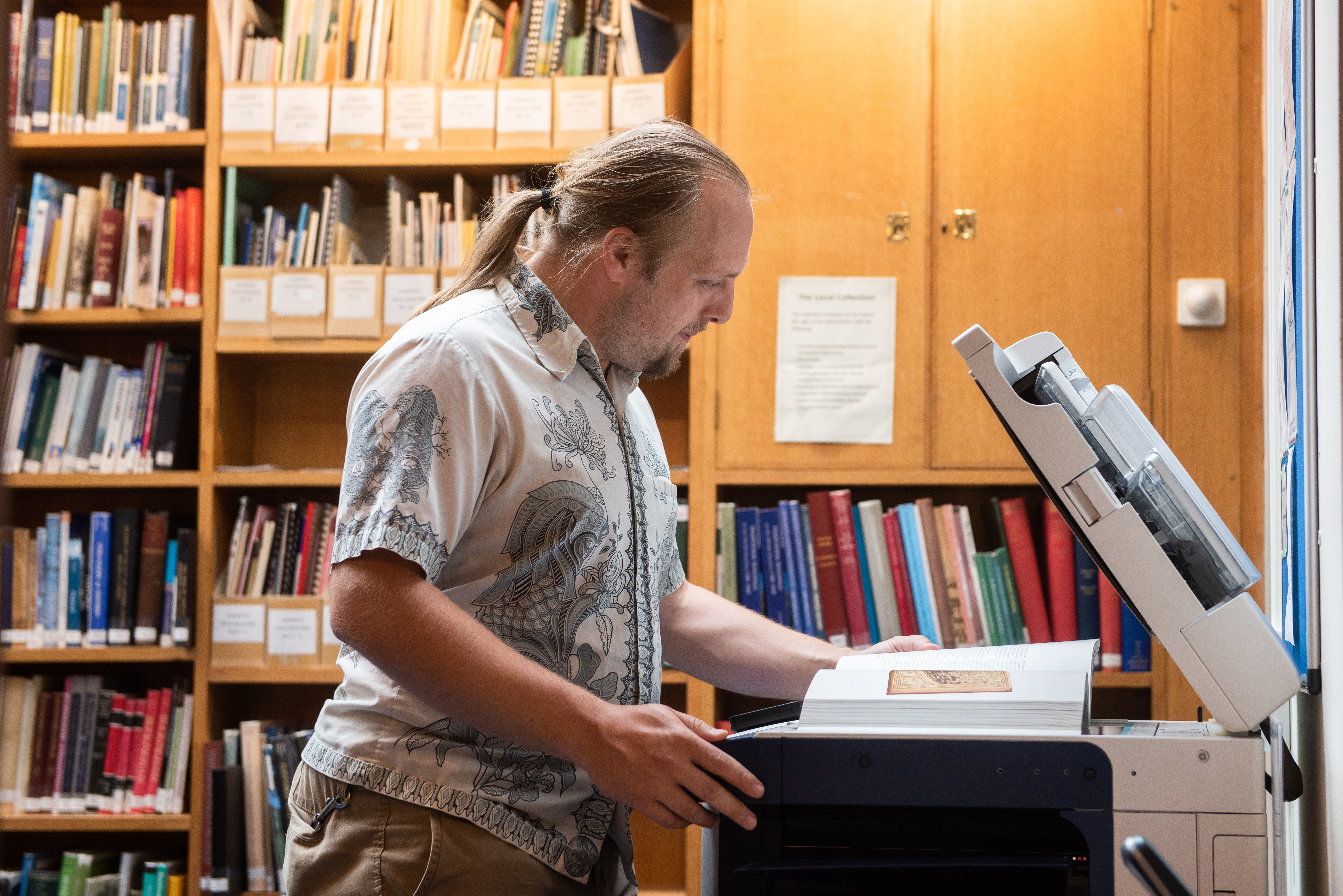 Full image of Dan uses the photocopier.