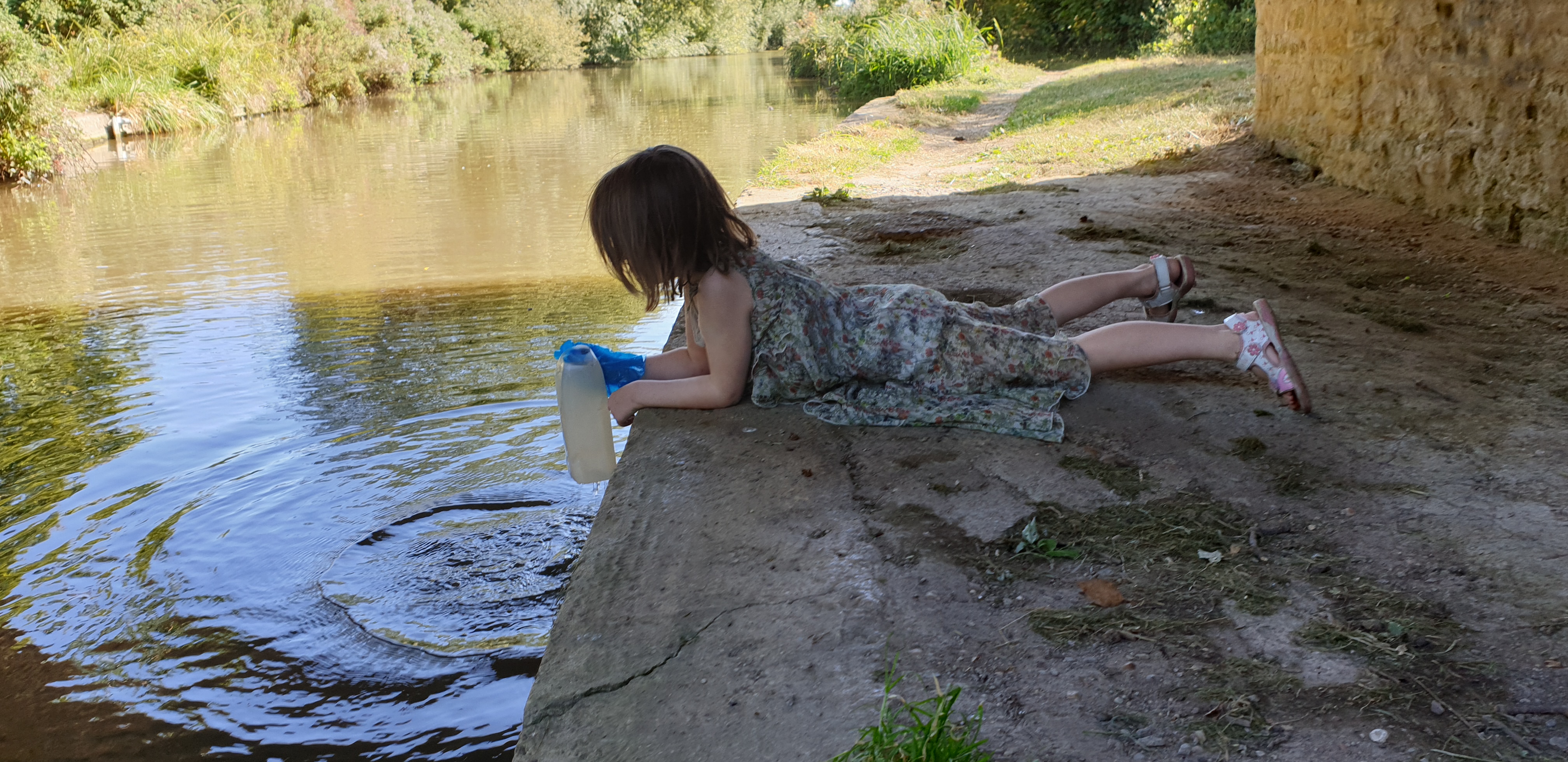 Full image of Annabel fetches water from the canal.