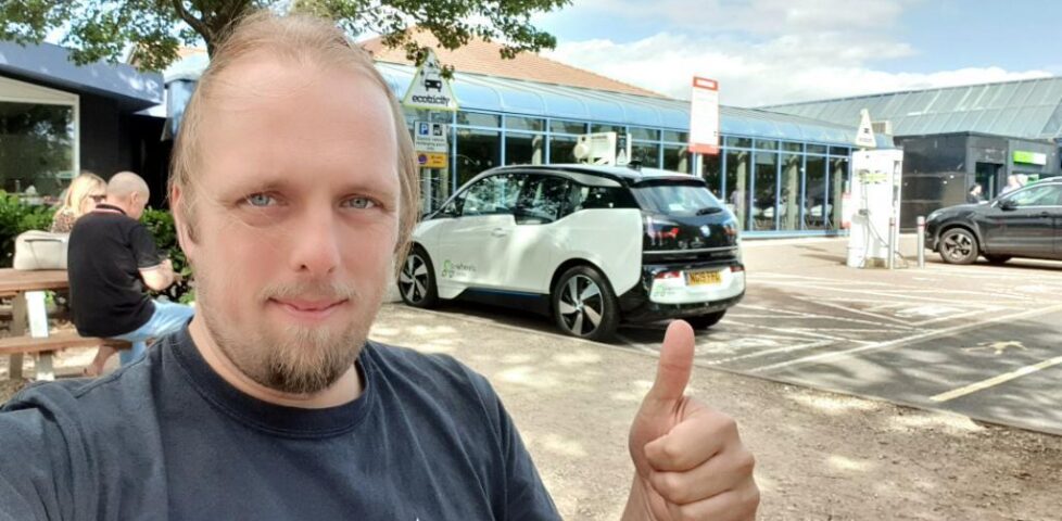 Dan and an eV at a charging point