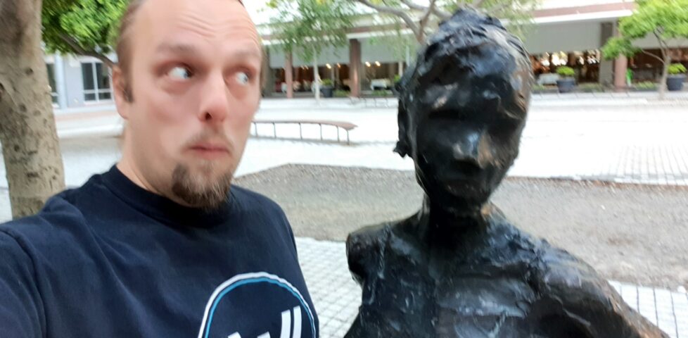 Dan with a statue at the GZ