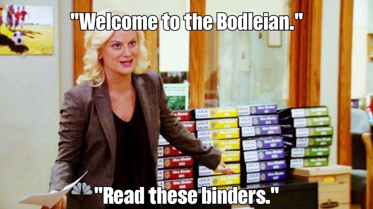 Full image of Leslie Knope (Parks & Rec) presents a pile of binders, saying 
