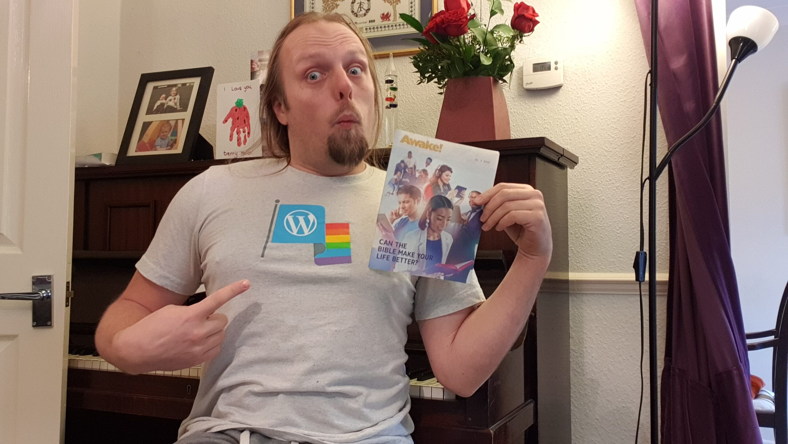 Full image of Dan with a copy of Awake!, wearing his WordPress Diversity t-shirt.