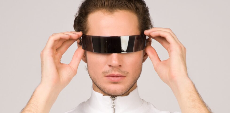 Man in sci-fi jumpsuit and futuristic AR goggles.