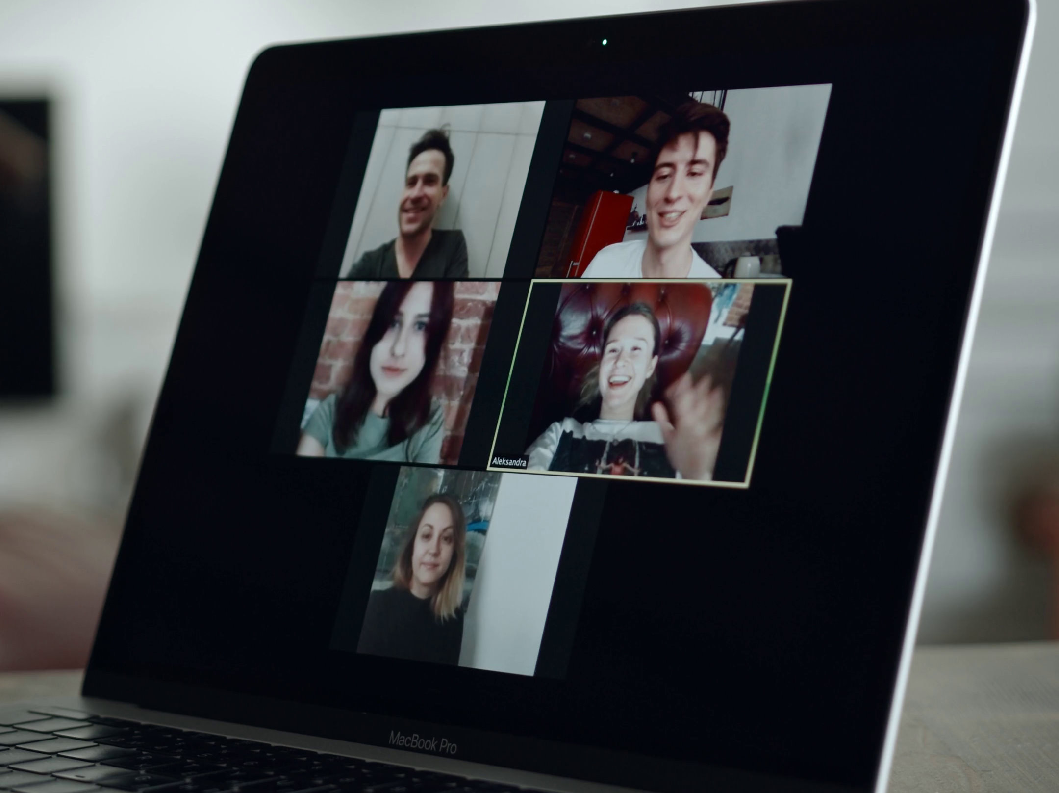 Full image of Laptop screen showing five people videoconferencing.