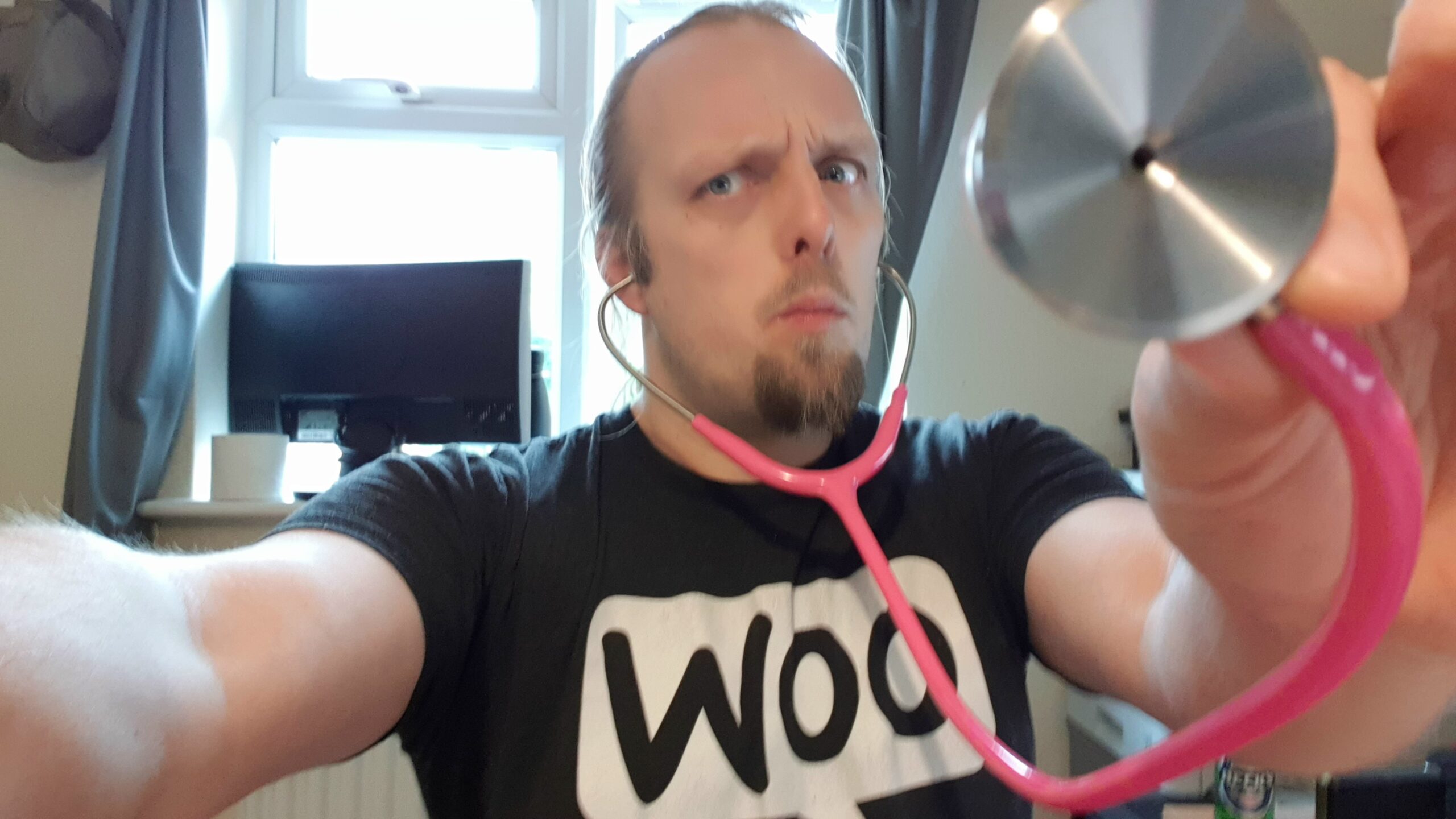 Full image of Dan with a pink stethoscope