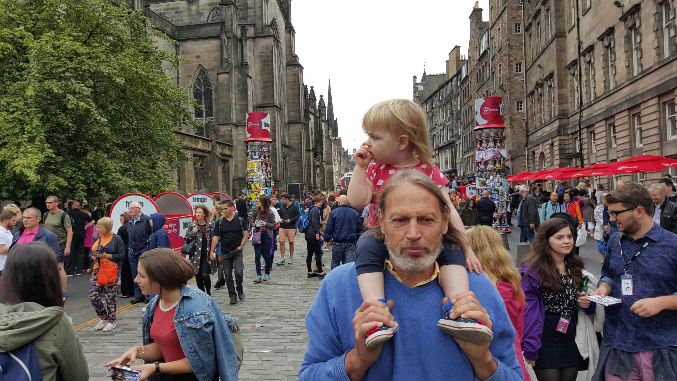Full image of Annabel riding on Tom's shoulders in Edinburgh.