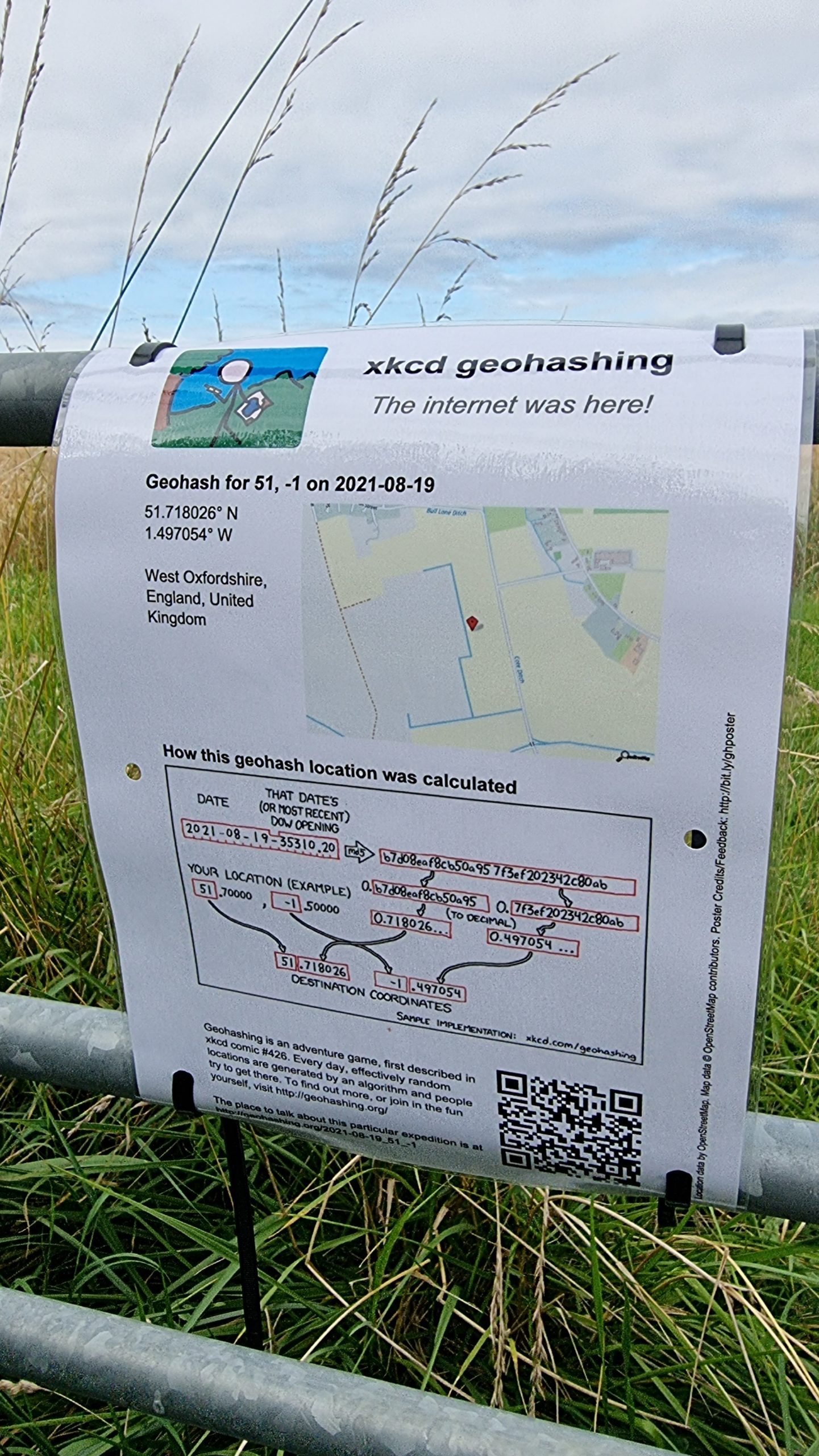 Full image of A "The Internet Was Here" sign explaining geohashing, attached to a gate using zip-ties.