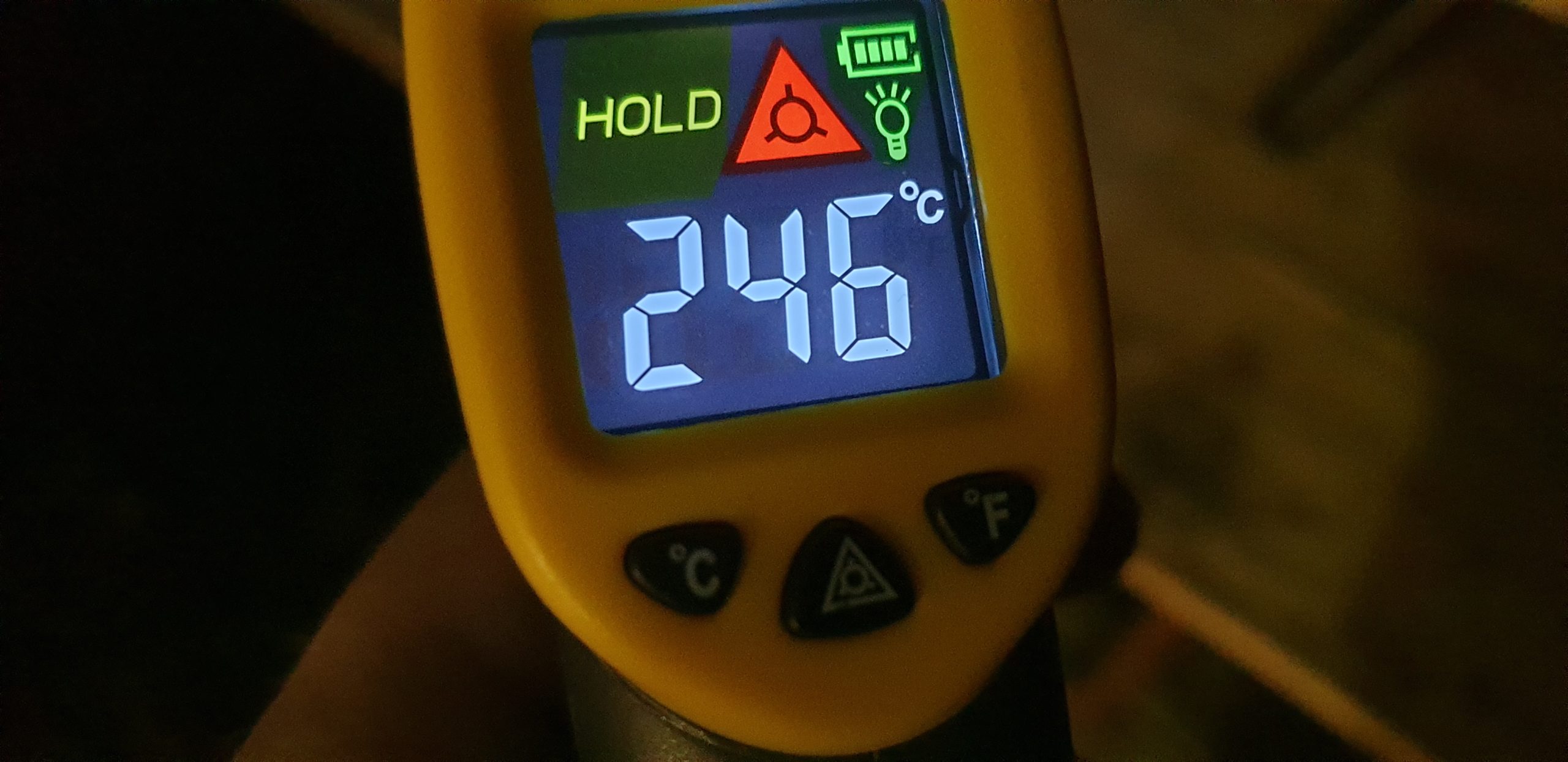 Full image of Digital infared thermometer display reading 246ºC.