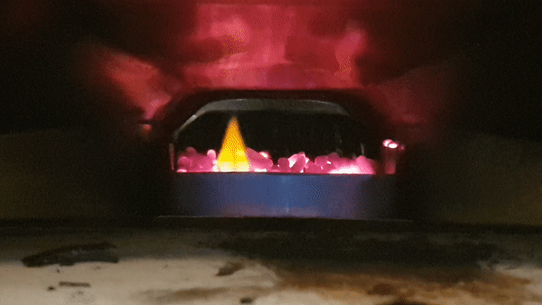 Flames flickering at the back of a pizza oven.