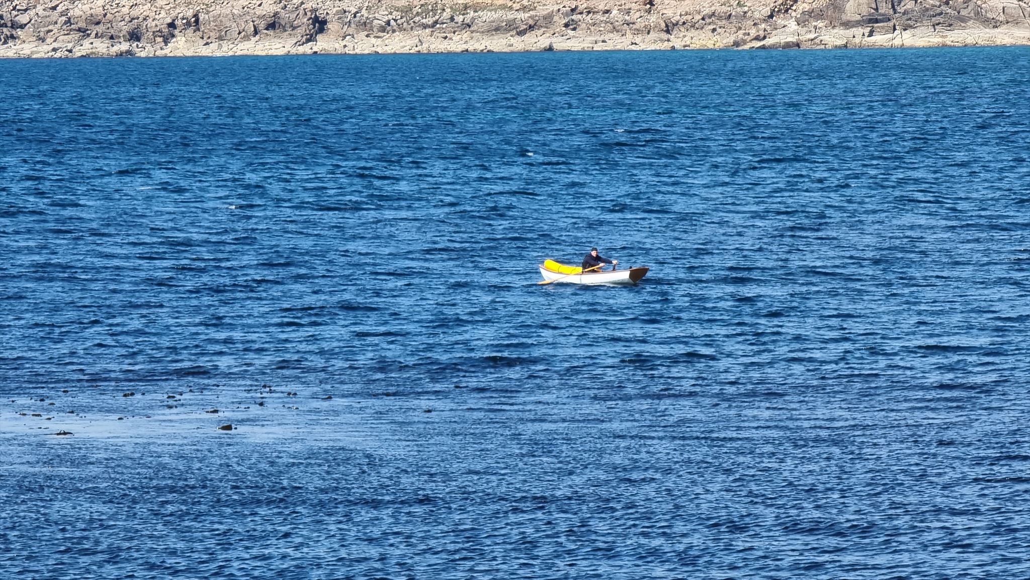Full image of Robin rows away from Sennen Cove and towards St. Ives