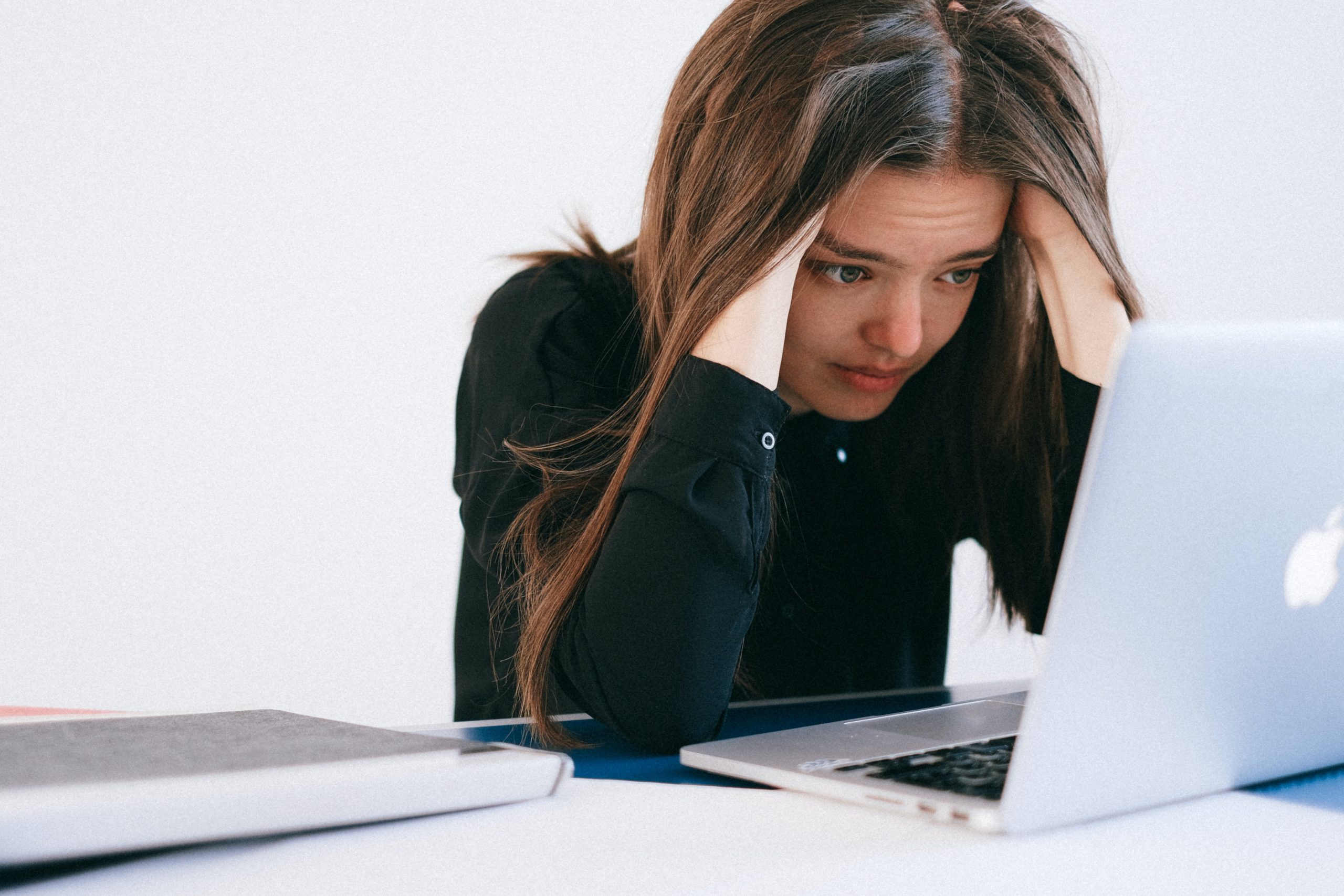 Full image of Stressed programmer hunched over a MacBook. Photo by Anna Shvets from Pexels.