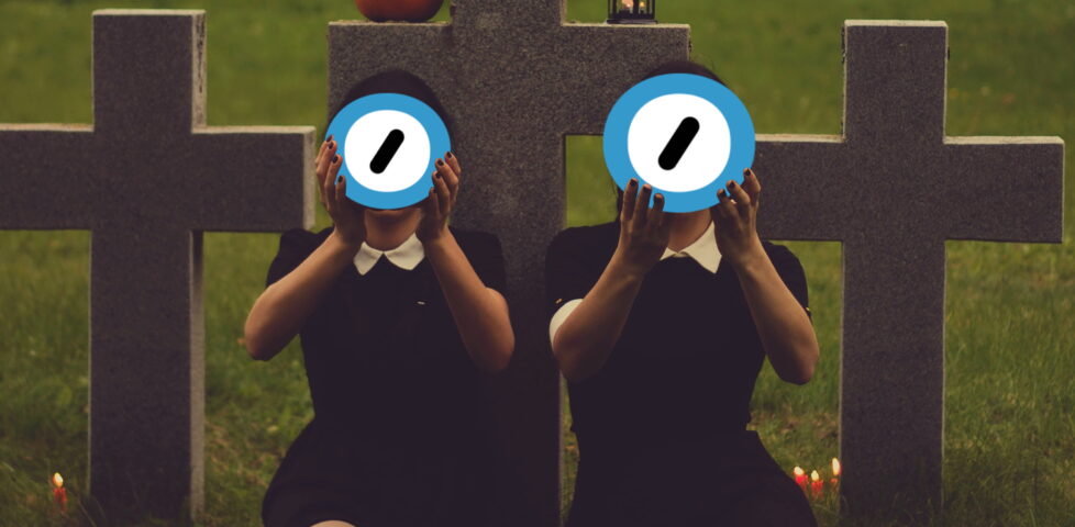 Two women in black dresses sit in a graveyard by candlelight and hold up the Automattic logo. Edited image based on original photo by Valeria Boltneva from Pexels (used with permission) and the Automattic logo (used under the assumption that they won't mind, given the context).