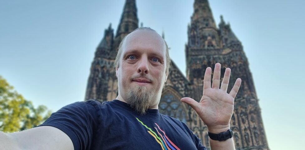 Dan in froint of Lichfield Cathedral, waving