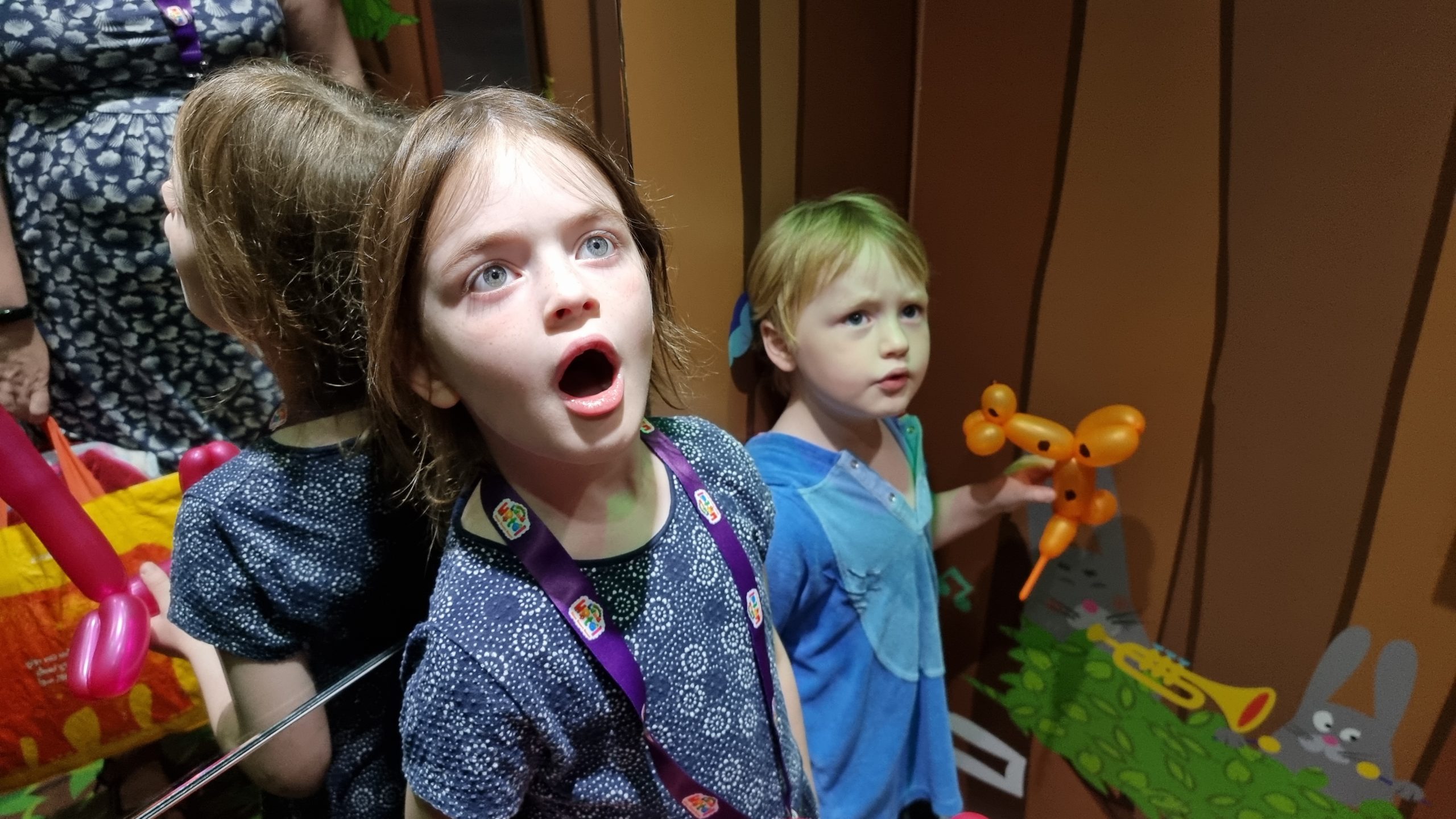 Full image of Kids in a decorated elevator.